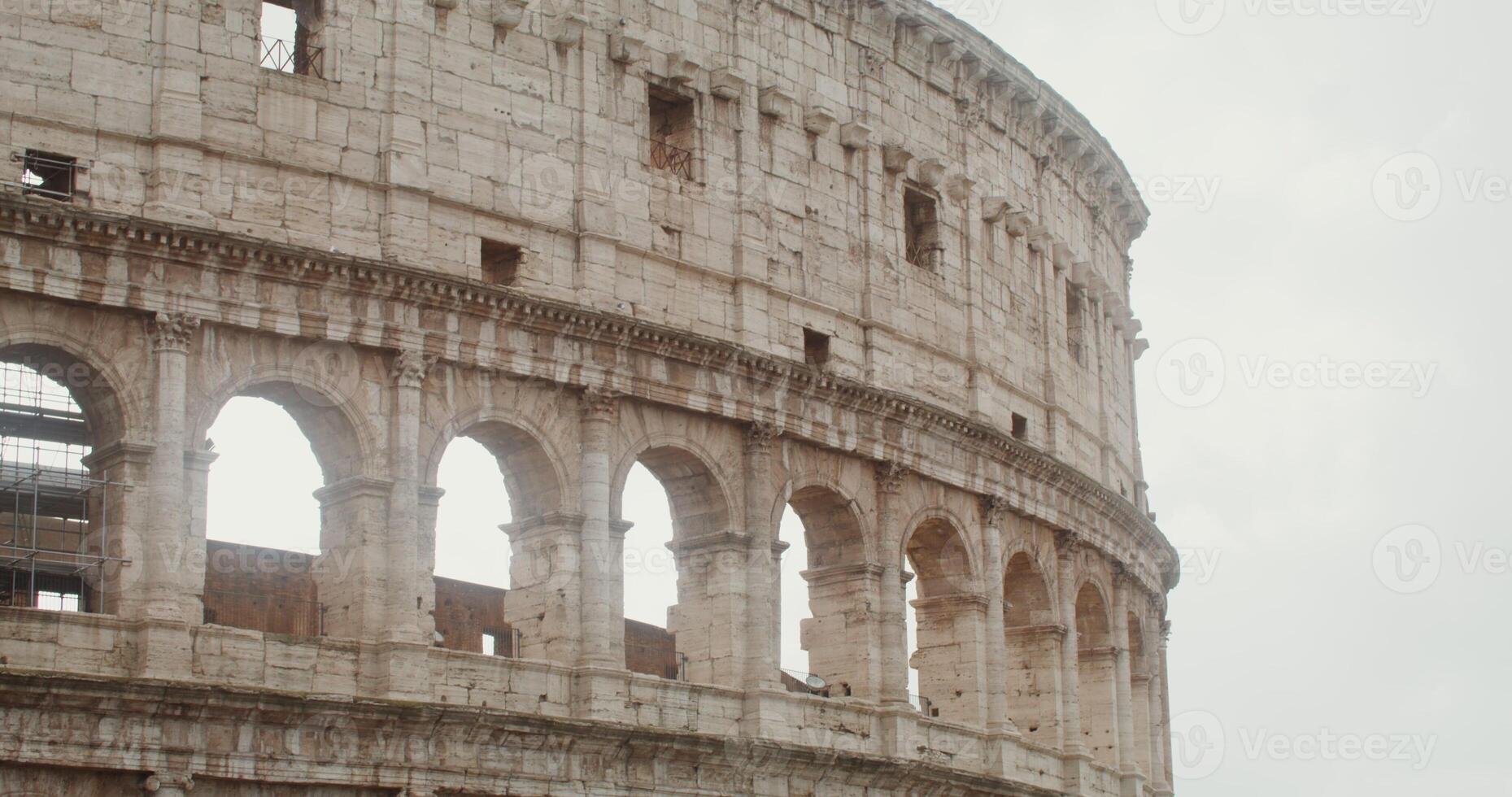 Colosseum, Italy, Rome. Close-up of a part of Rome's tourist attraction against a clear sky on a sunny day. in 4k, red komodo photo