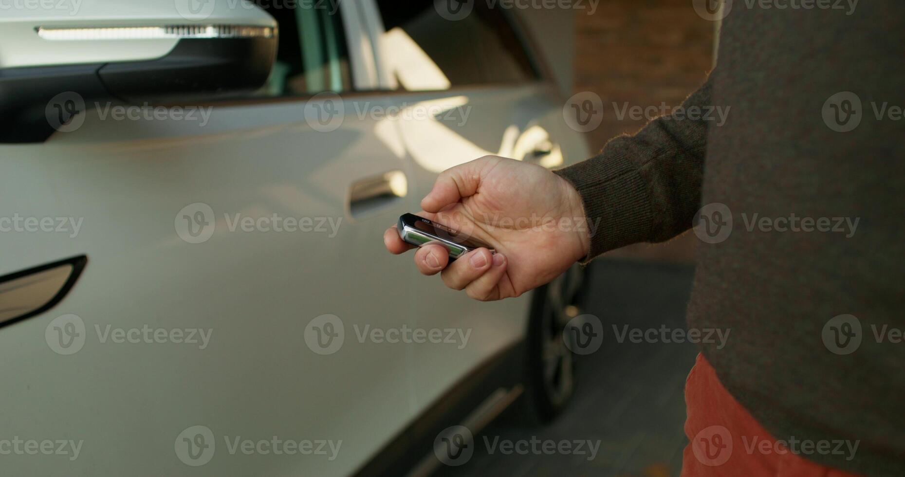 A man opens the car, close-up of his hands with a key, an unrecognizable person - unrecognizable photo