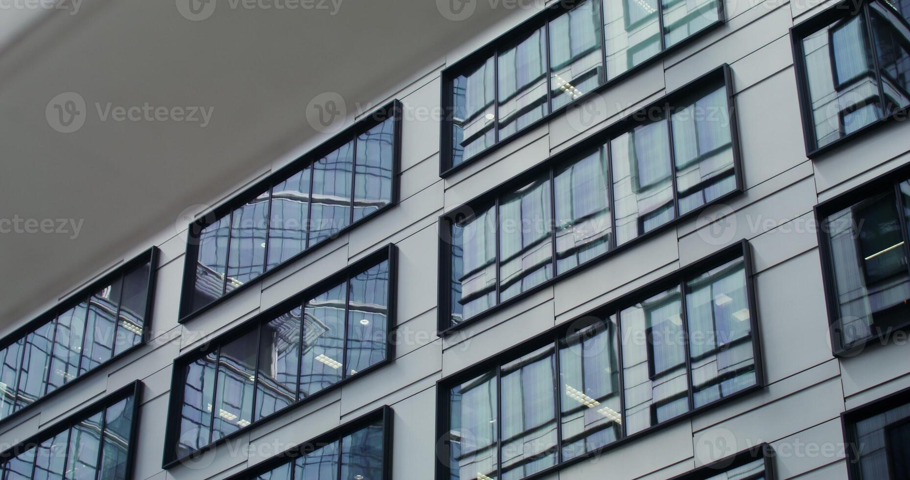 Facade of an office building with large panoramic windows. Business Quarter, no people on . The gray building of the business center. in 4k, red komodo - building photo