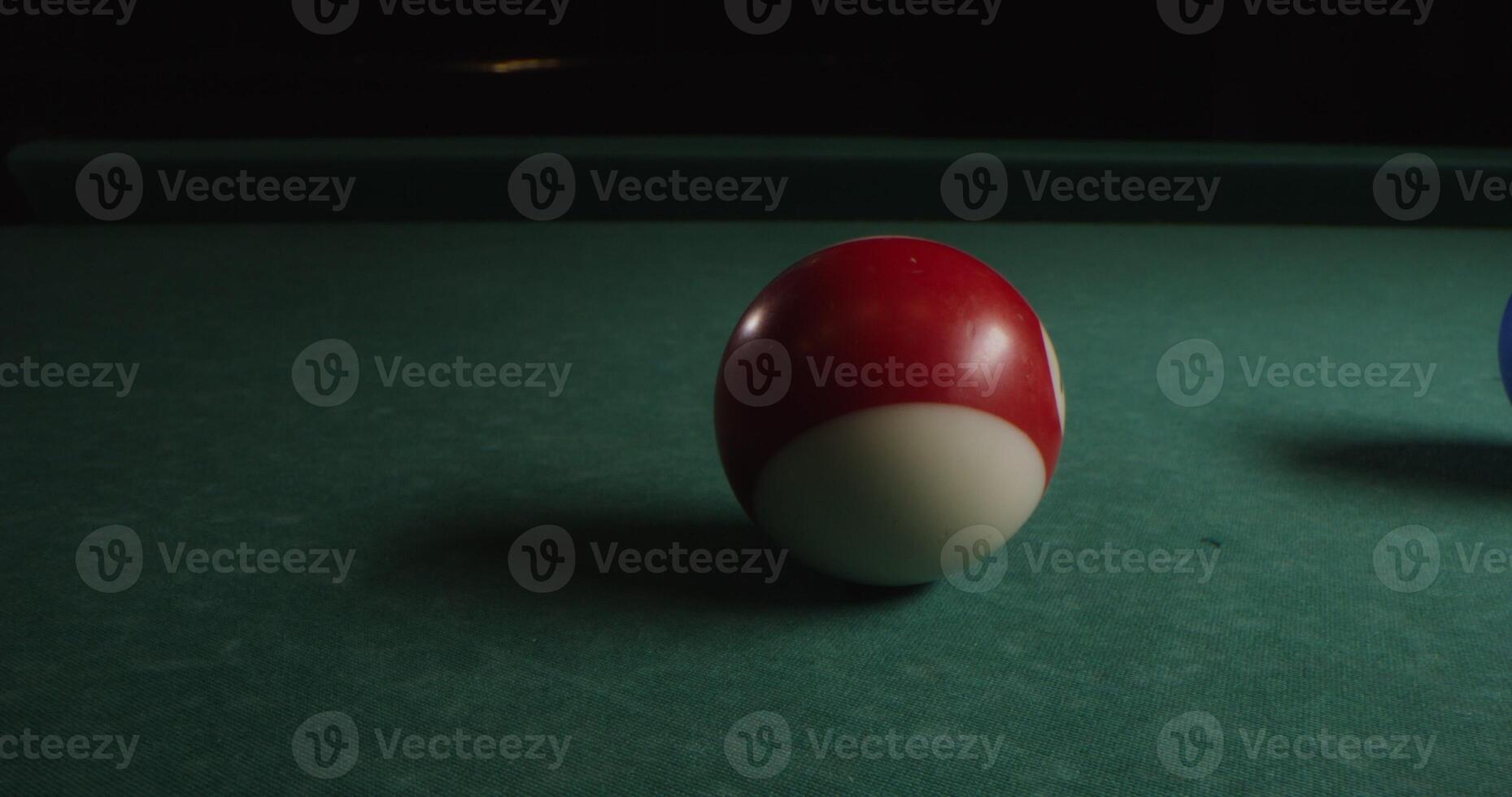 Multi-colored billiard balls in a chaotic manner lie on the billiard table, slow shooting without moving objects, without people in the frame - manner photo