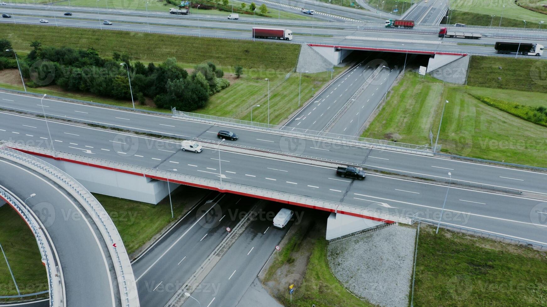 filming from a drone, a view of the road junction with cars moving along it. Aerial view, from quadrocopter photo