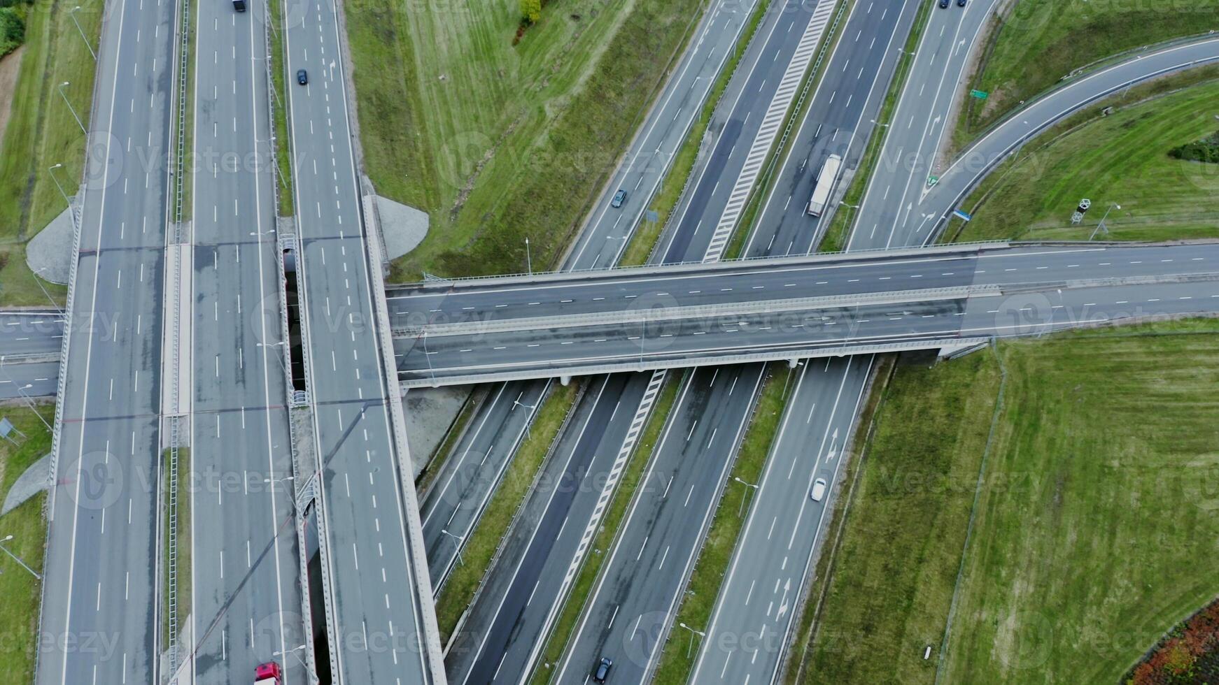 Multilevel road, top view, filming from a quadrocopter. View of the road junction with cars passing along it, shooting from a drone - passing photo