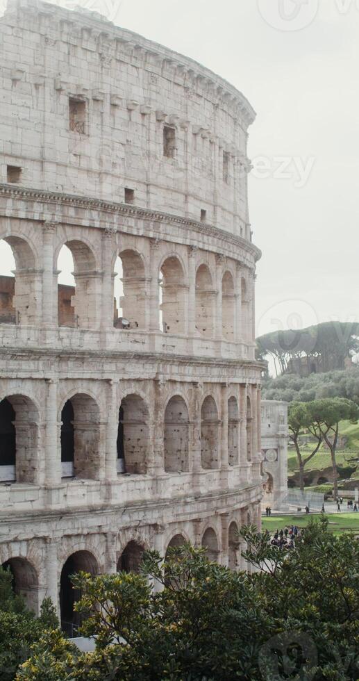 Close-up of the side of the Coliseum on a sunny warm day. Italy tourist attraction, Rome. in 4k, red komodo, vertical photo