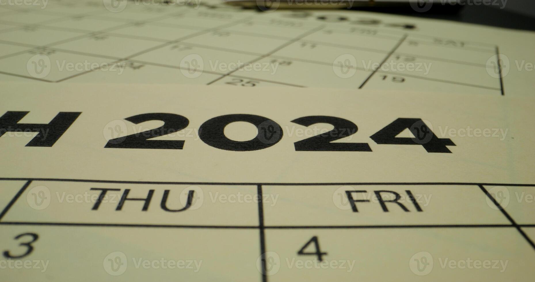 A person crosses out the year in the schedule table with a red marker. Close-up of the marker, an unrecognizable person - schedule photo
