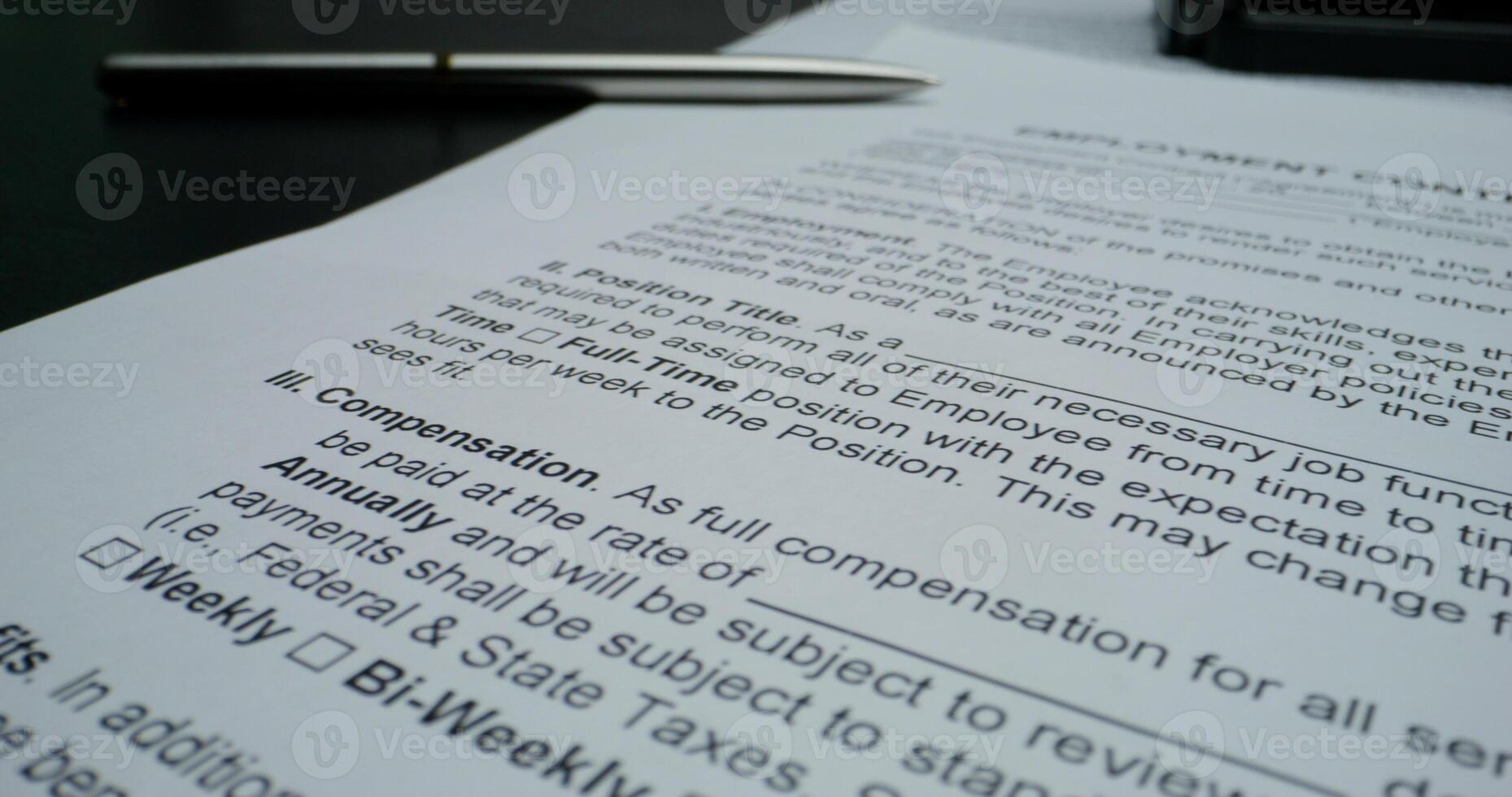 The documents are on the table, close-up. An employment contract. The pen is on the paper - documents photo