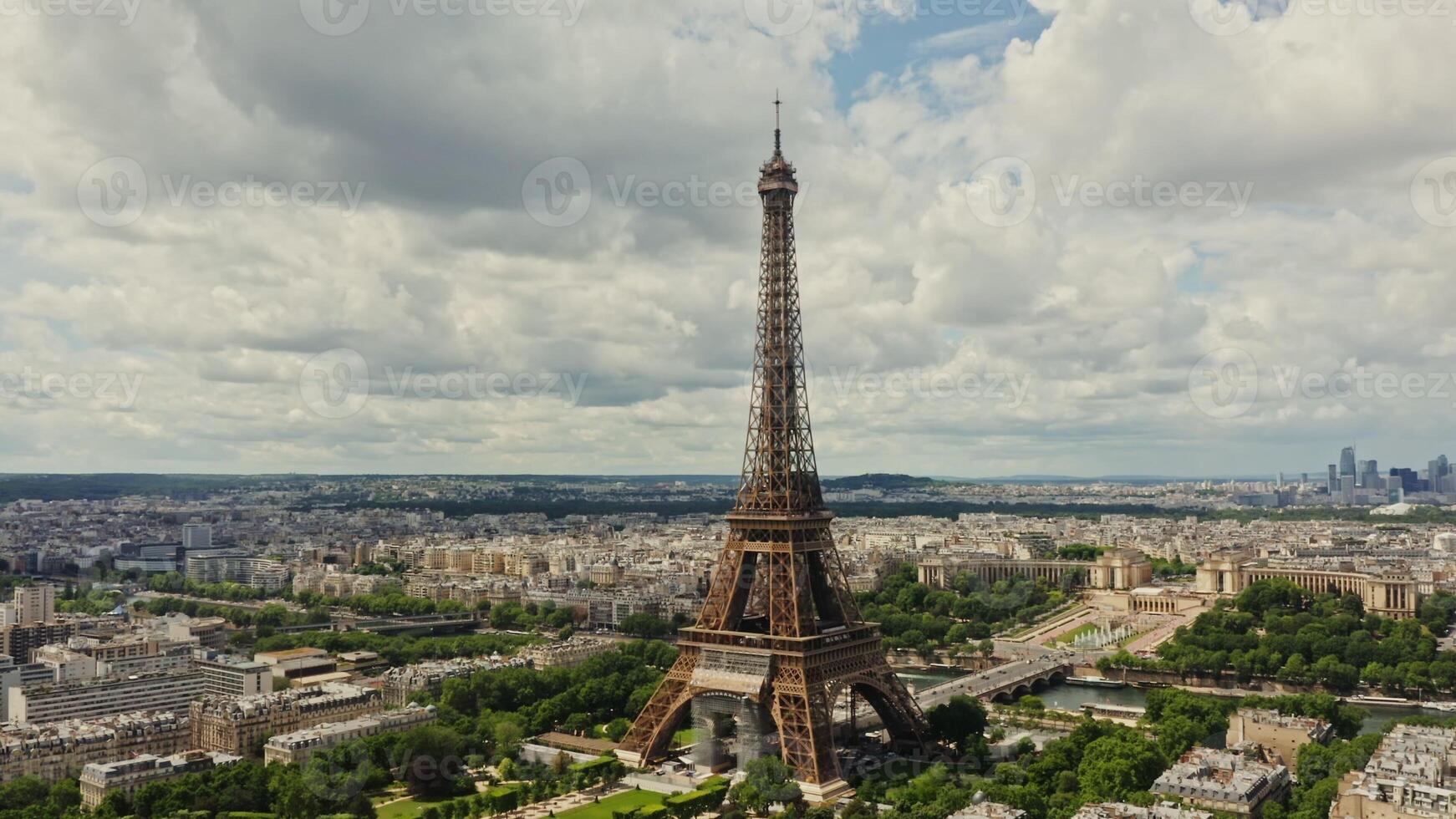 Drone horizontal panning view of the historic center of Paris with the Eiffel Tower and the Seine River in the foreground on a summer day. France Paris - center photo