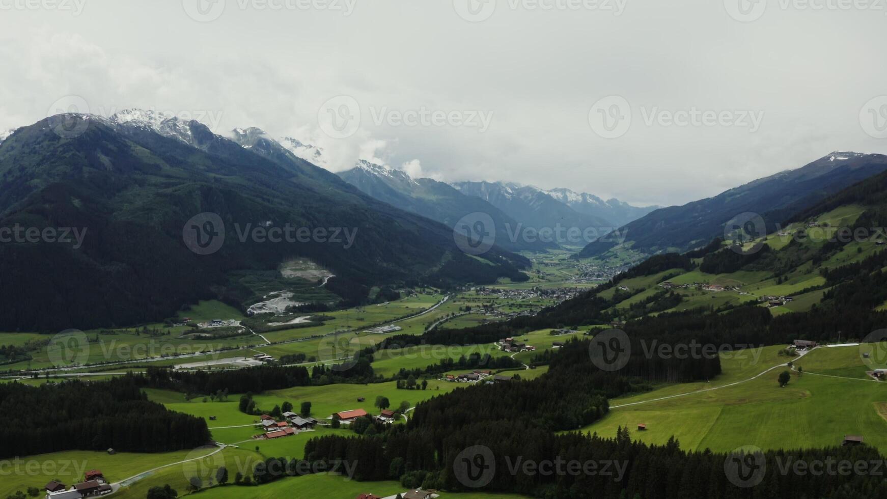 Panoramic view of the picturesque mountain valley with cottage houses in the lowland, located at a distance from each other. Bird's eye view , Alps, Austria - mountain photo
