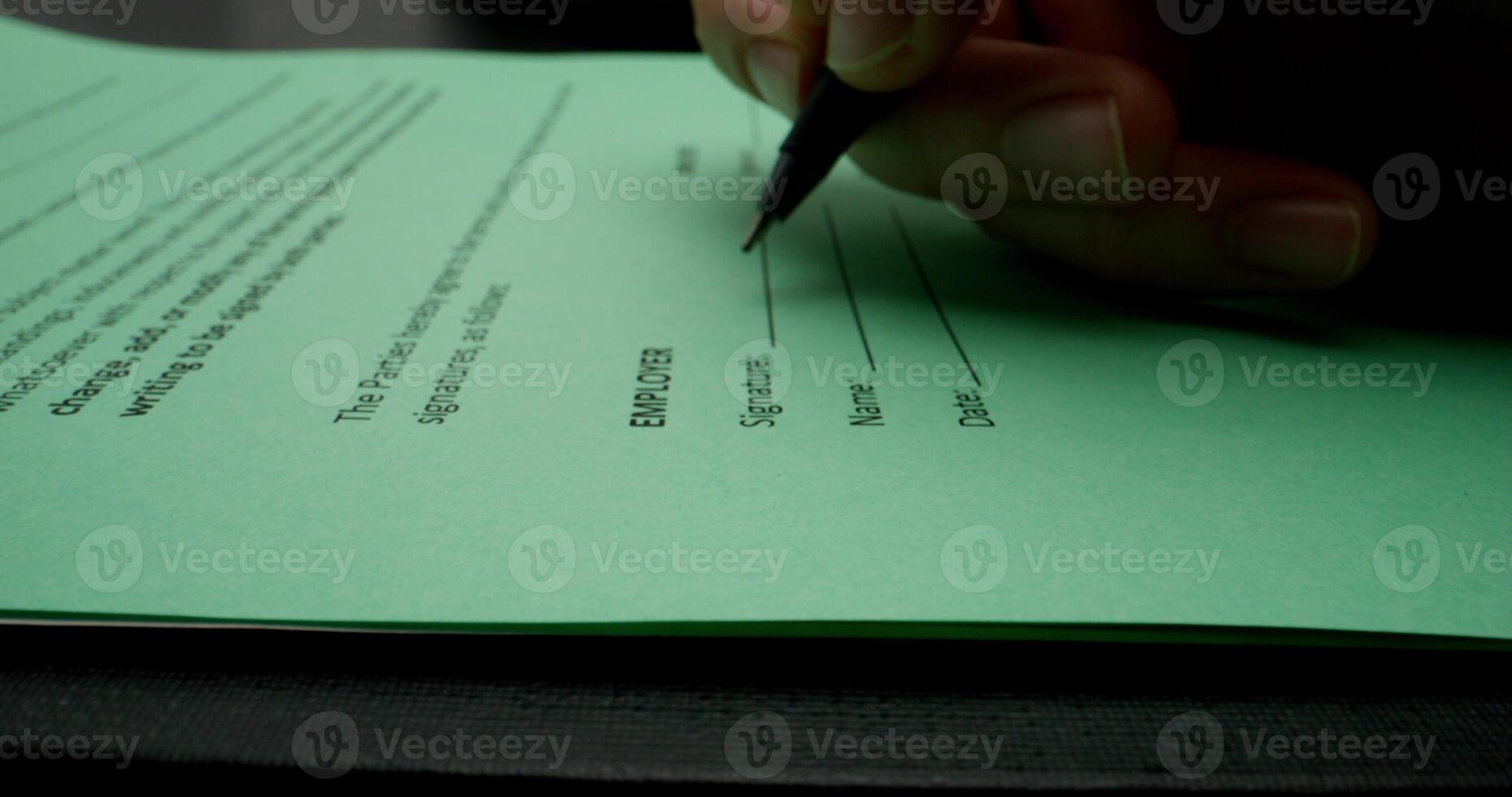 A man puts his signature on behalf of a company representative, close-up of his signature, an unrecognizable person - unrecognizable photo