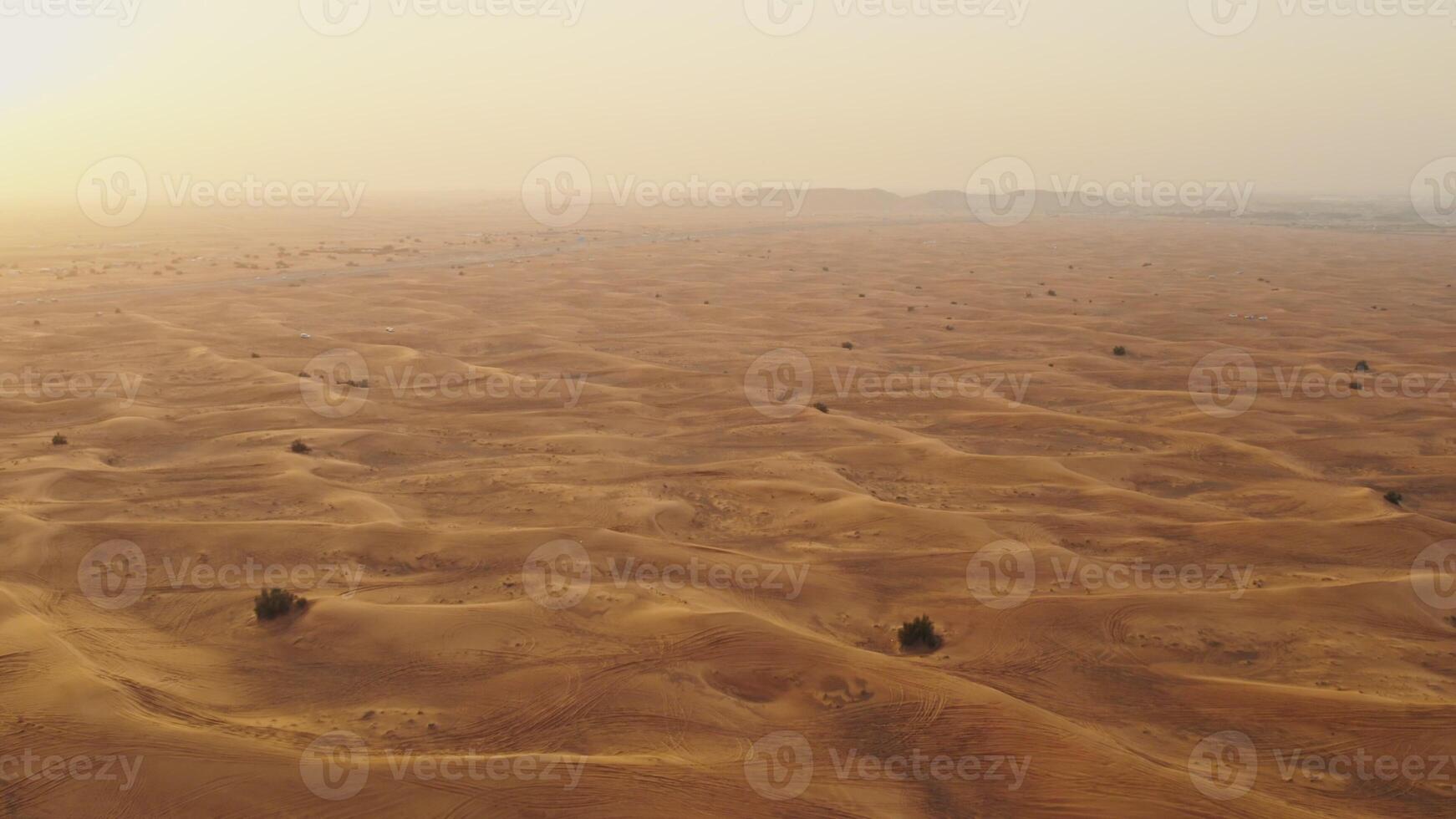 Drone view of sand dunes with sand merging with the sky. Driving off-road in a lifeless desert photo