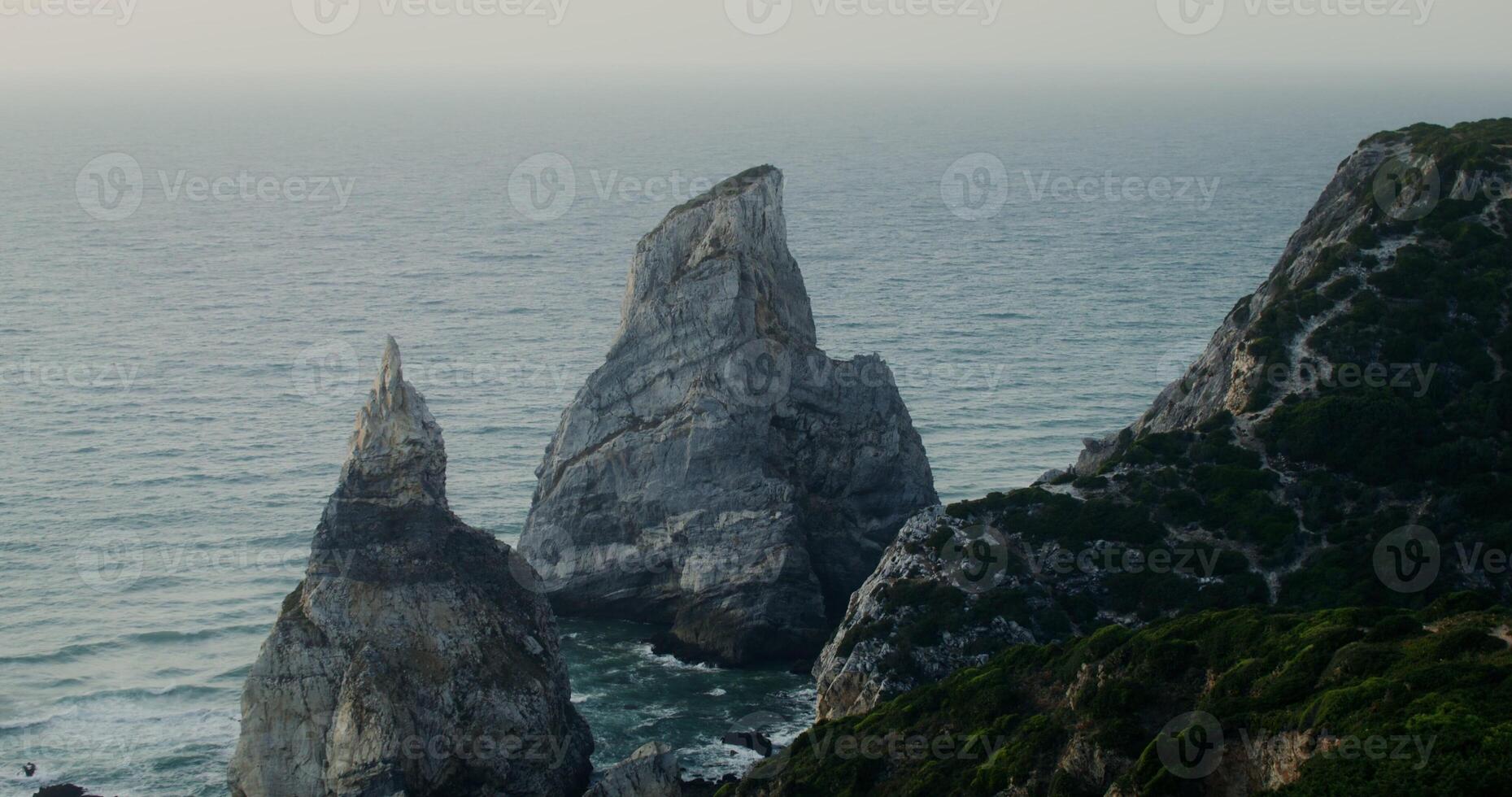 Top view of the coastline. Rocks sticking out of the water, shallow reef photo