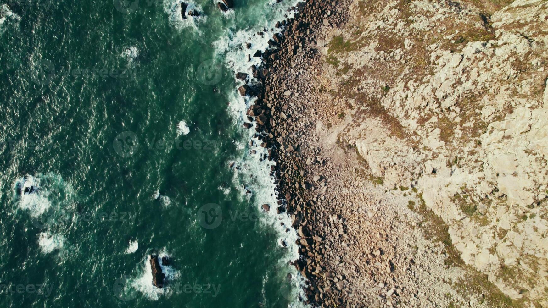 Top view of the sea waves washing the pebble beach. Drone on a summer day - summer photo