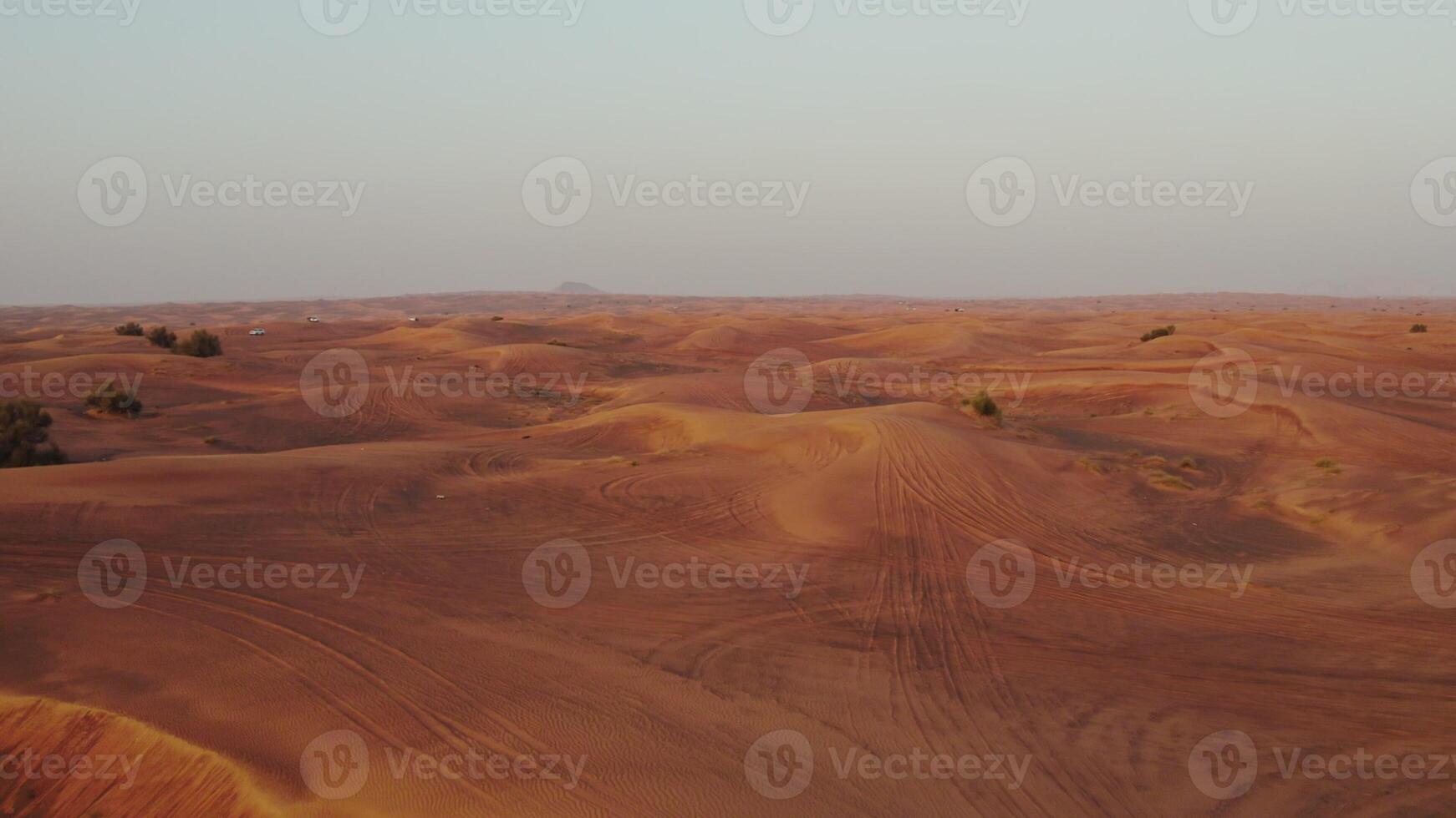 A bright red desert. Sand dunes from a bird's-eye view. Contrasting view of the sand with the sky photo