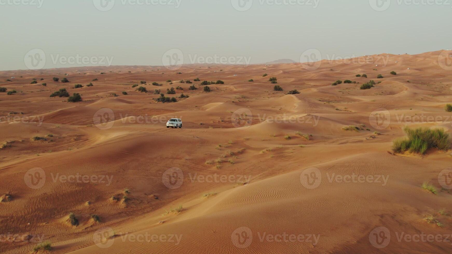 The car goes off-road on the sand dunes of the desert, drone - Scene 2 photo