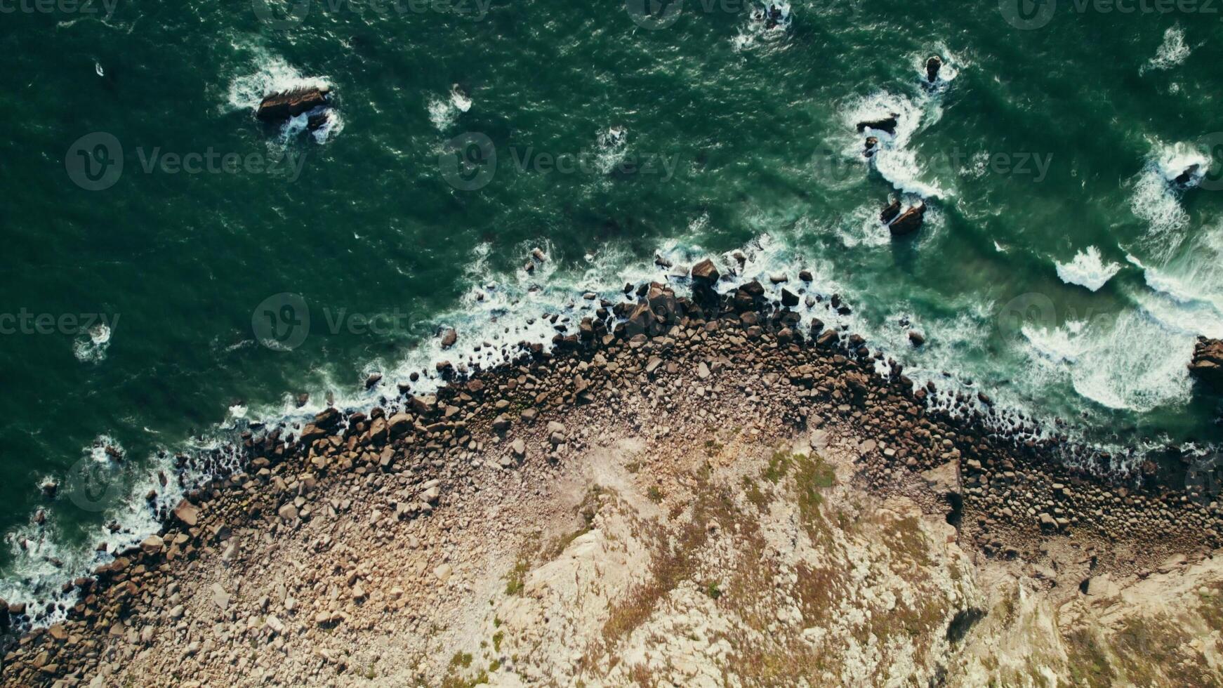 Top view of the sea waves washing the pebble beach. Drone on a summer day photo