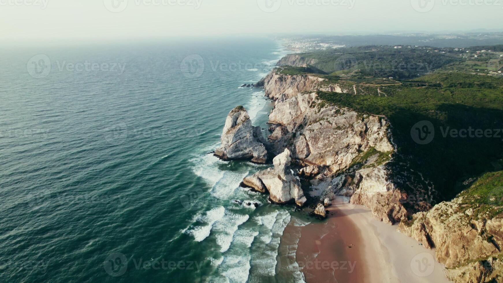Bird's-eye view of the sea coastline with a sandy beach and stone cliffs - cliffs photo