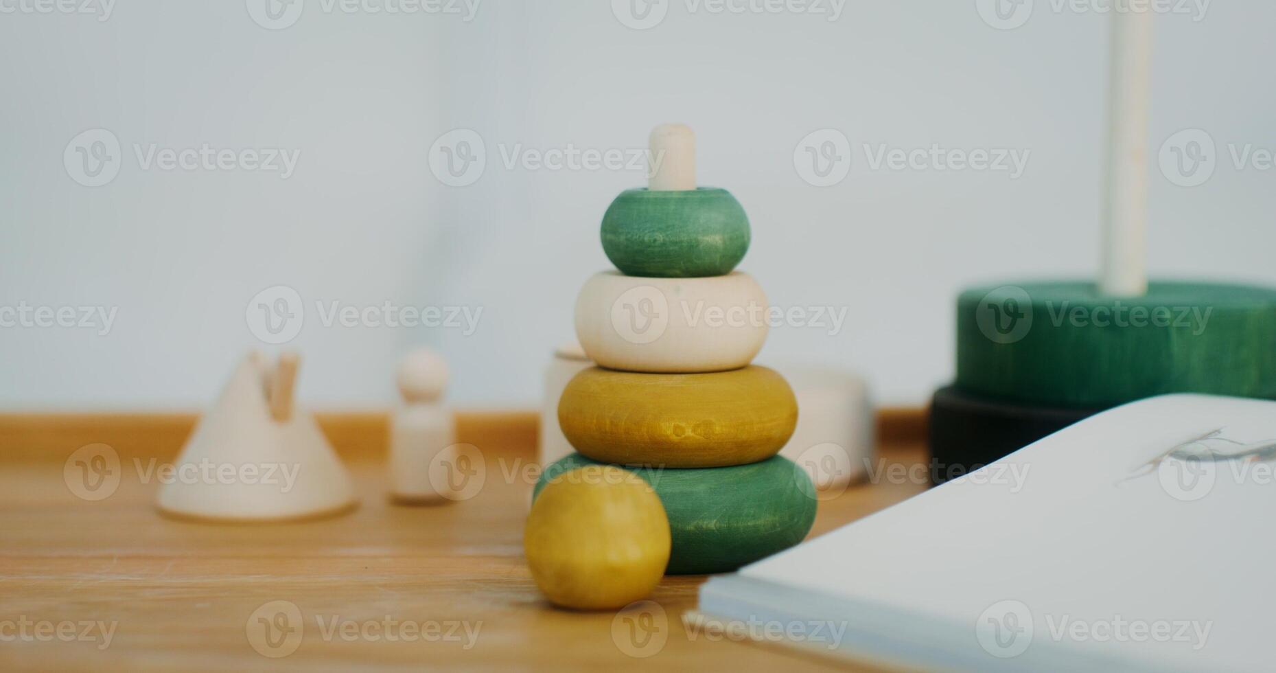 Wooden toys of natural shades are on the table in a bright interior, there are no people - people photo