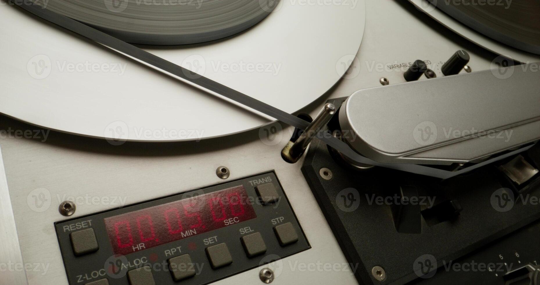 Sound recording on a tape recorder in a recording studio. Fast movement of the magnetic tape, close-up - recording - a photo