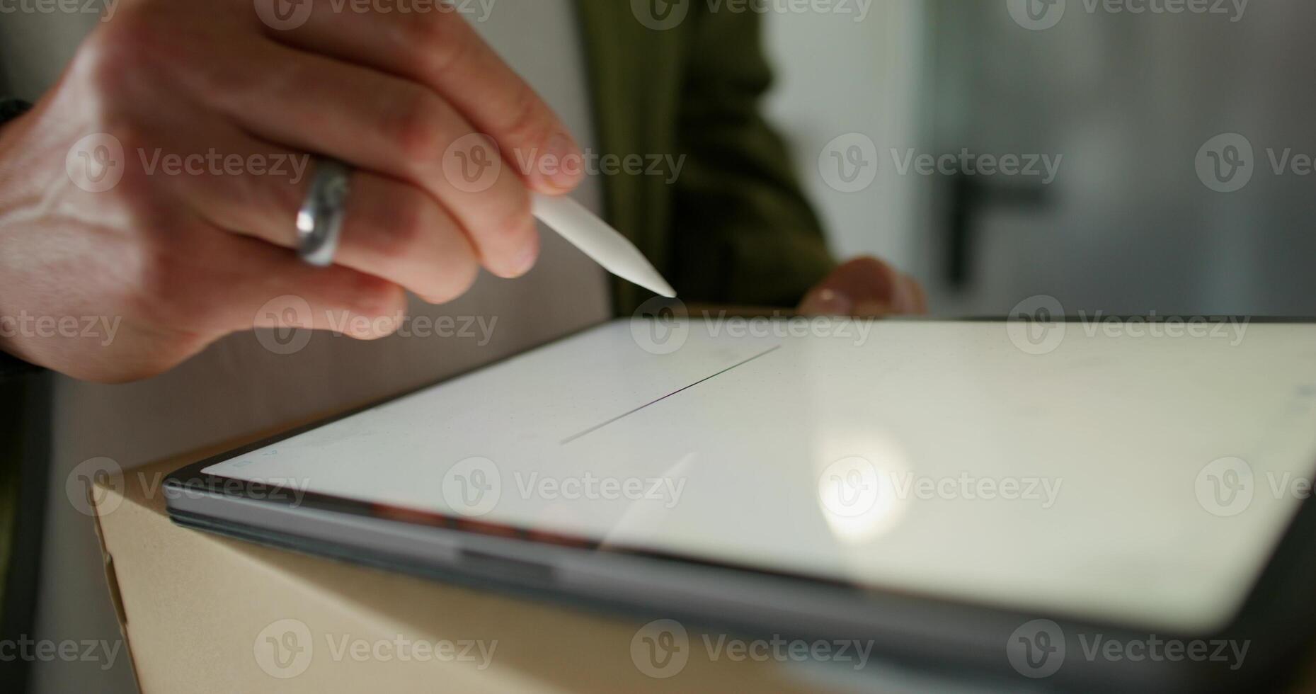 The man signs with a stylus on the tablet confirming receipt of the parcel. close-up of his hands, an unrecognizable person - unrecognizable photo