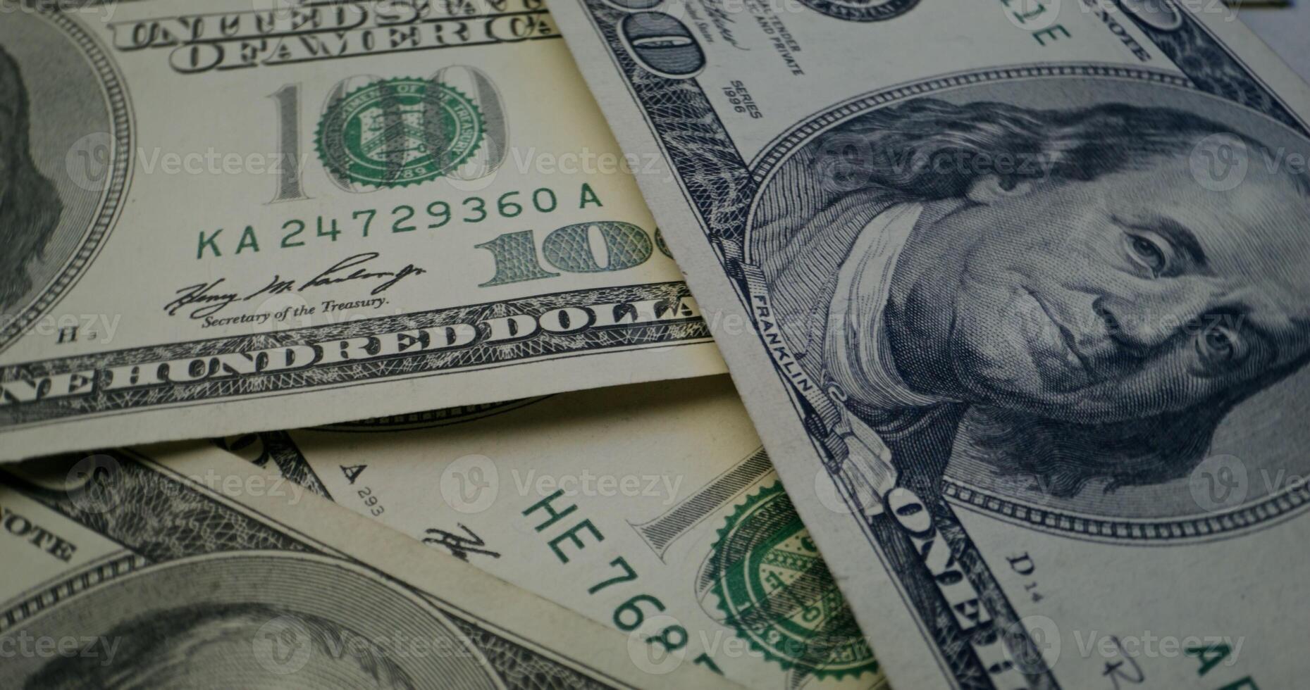 Hundred dollar bills are scattered on the table. Overview of the details of paper money - dollar photo