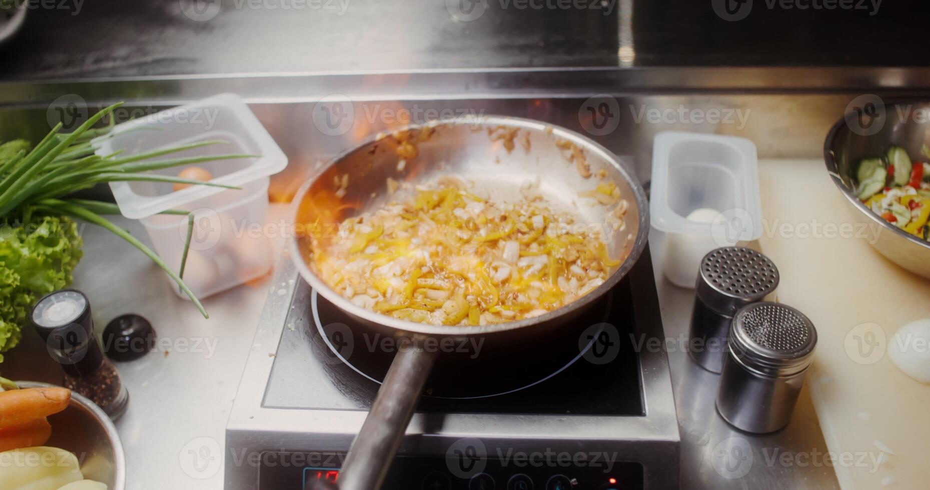 A woman in disposable black gloves adds spices to frying in a frying pan food, close photo
