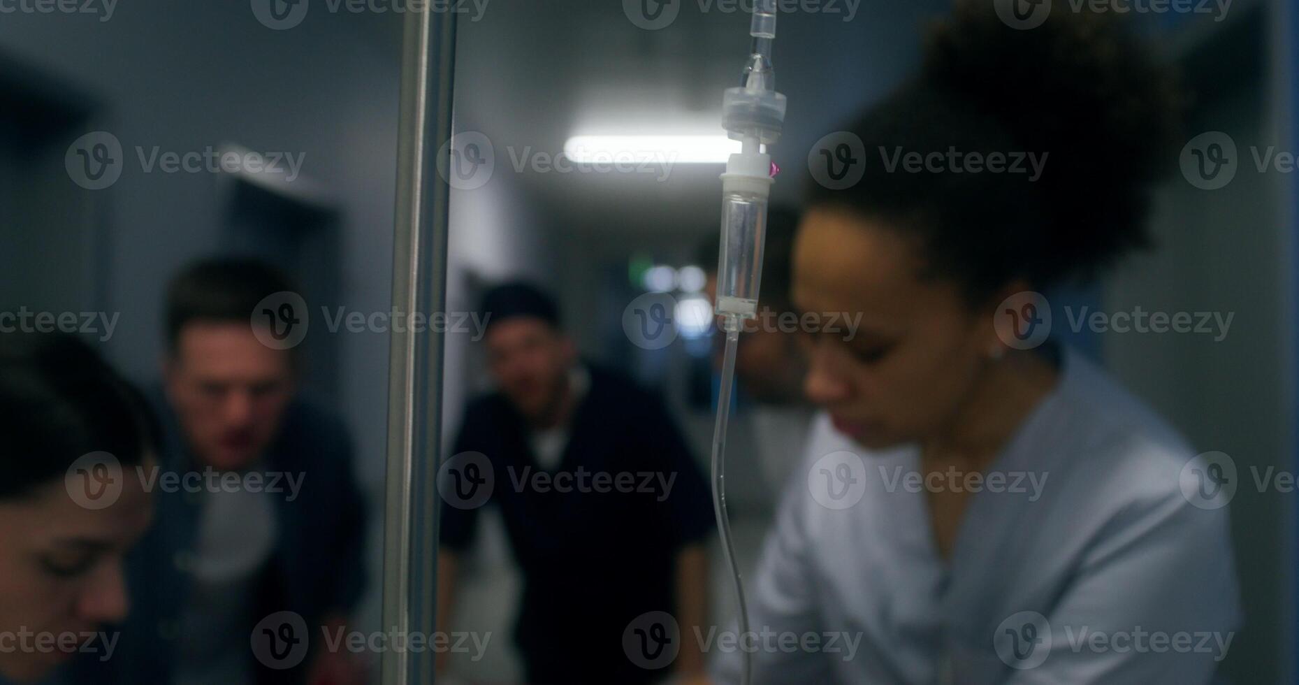 Medical staff and relatives of the victim are running down the hospital corridor carrying the patient on a gurney photo