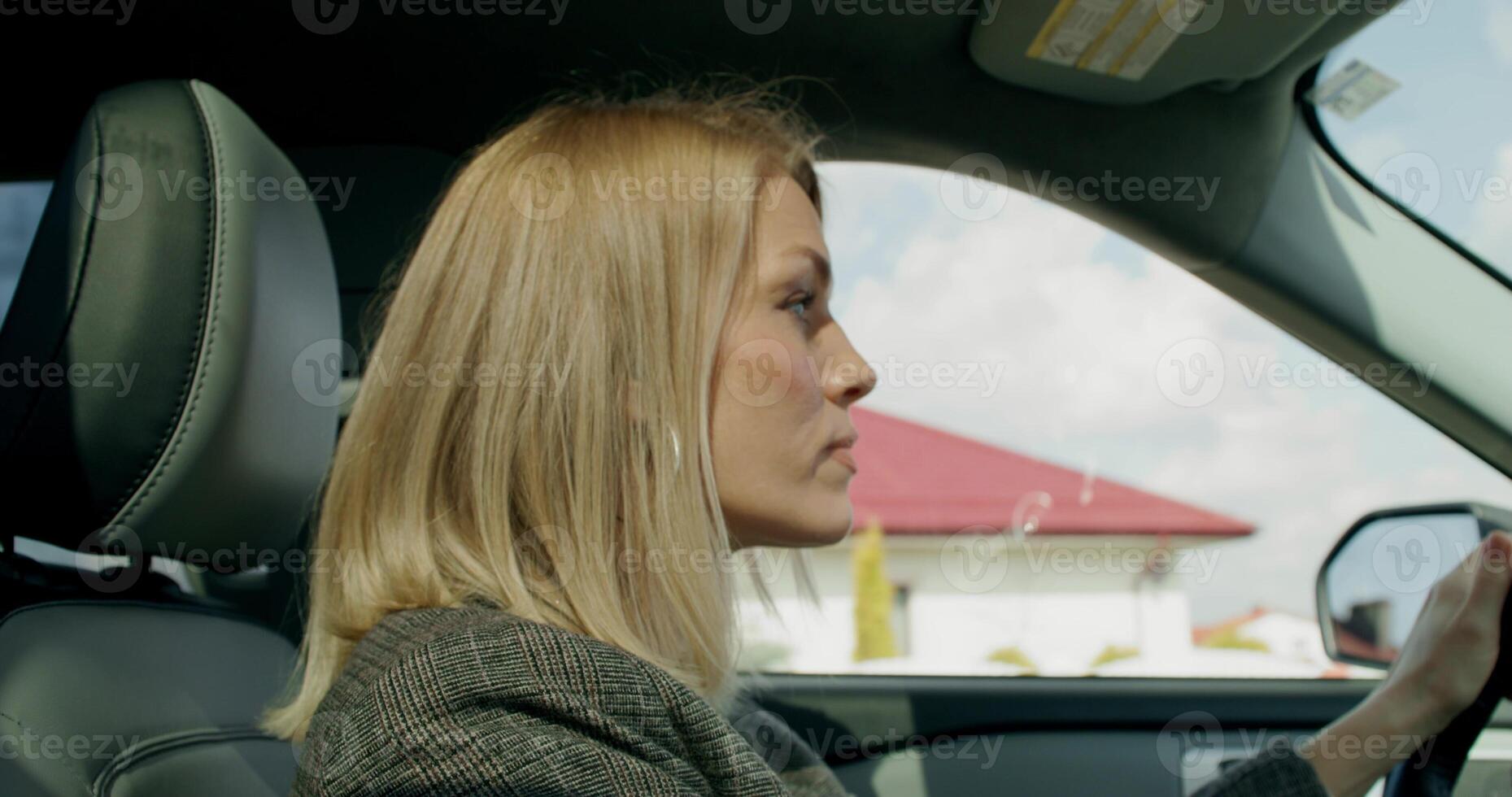 A business woman drives a car around the city on a sunny day. View from the salon - business - woman photo