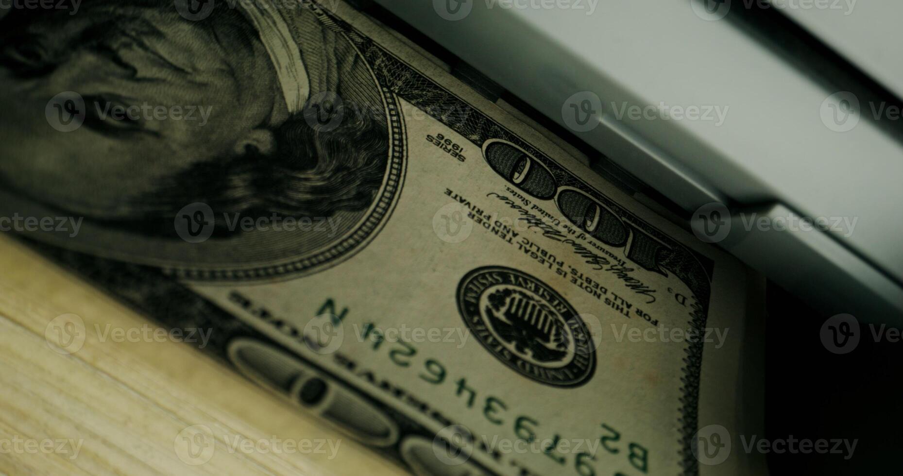 The calculating machine counts a stack of dollar bills, close-up photo