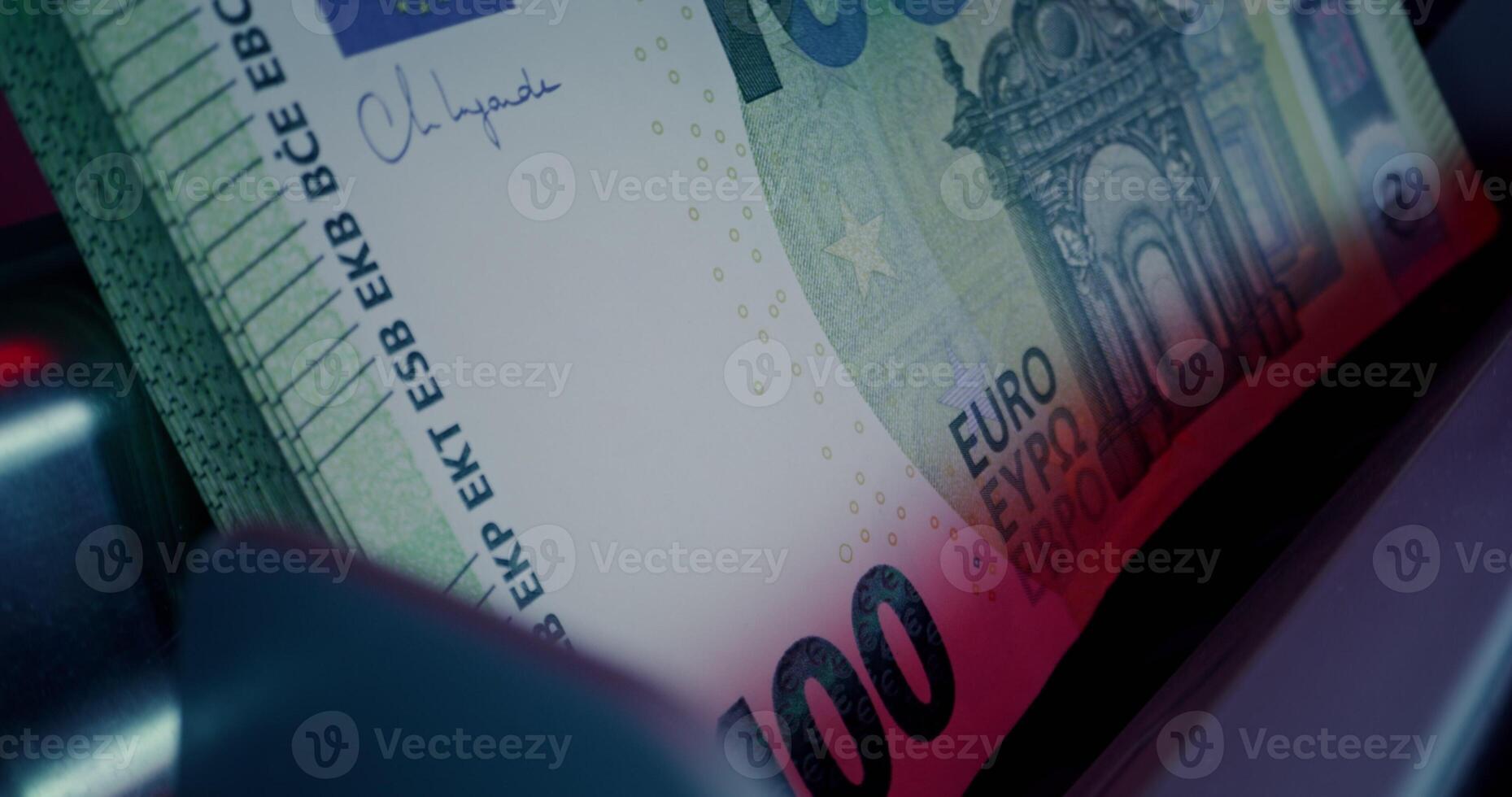 The calculating machine counts a stack of euro bills, close-up photo
