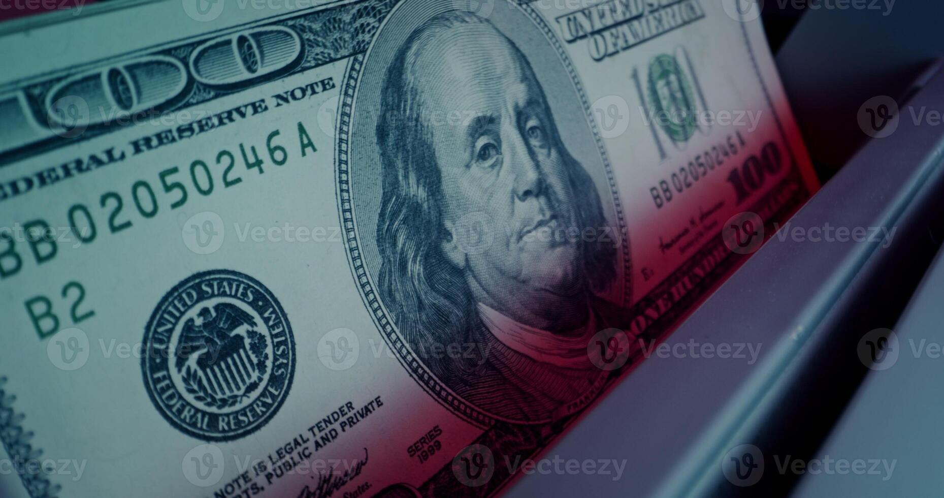 The calculating machine counts a stack of dollar bills, close-up - counts photo