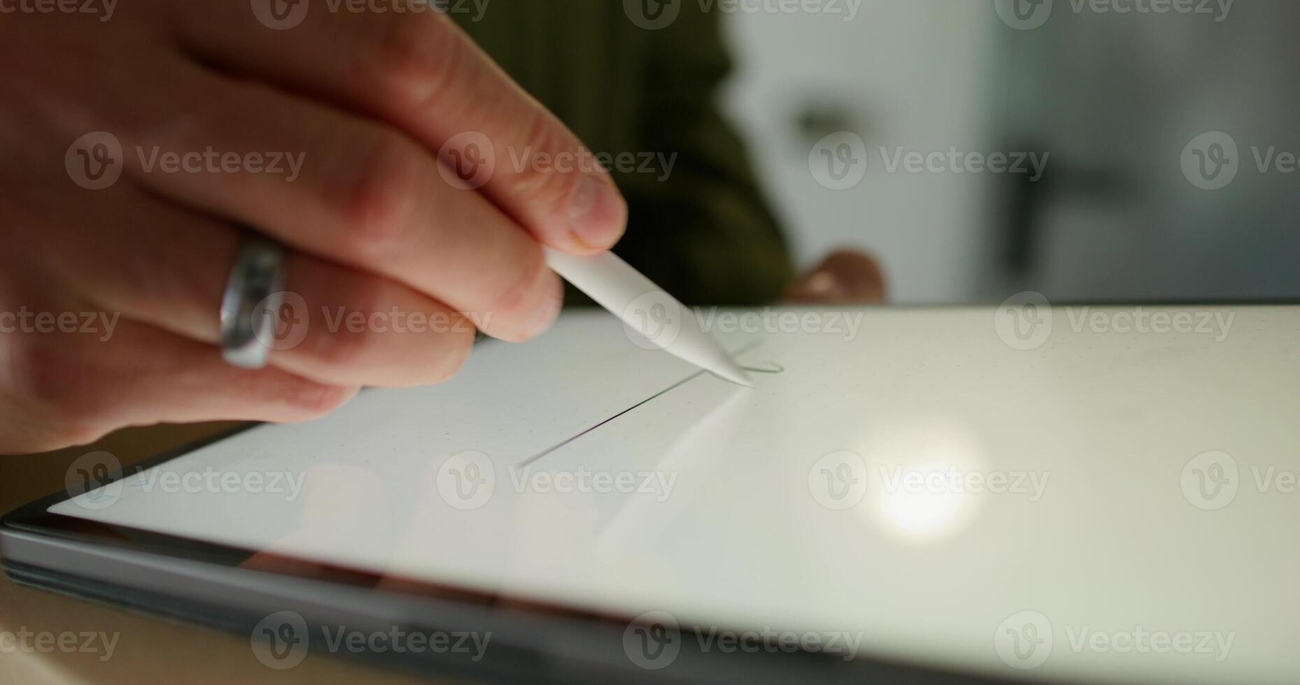 The man signs with a stylus on the tablet confirming receipt of the parcel. close-up of his hands, an unrecognizable person - receipt photo
