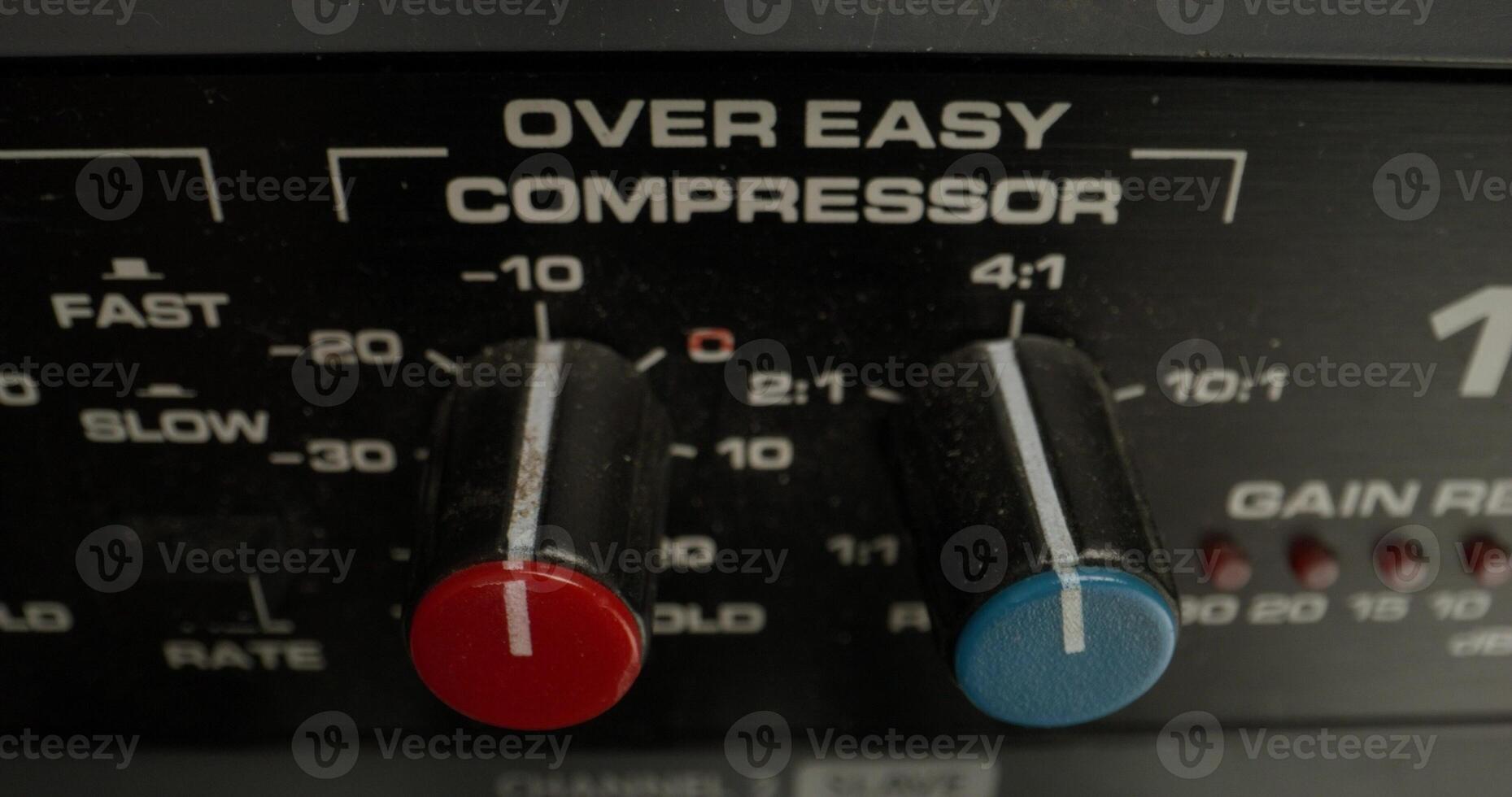 A man adjusts a vocal compressor in a recording studio. Close-up of his hand, an unrecognizable person - recording photo