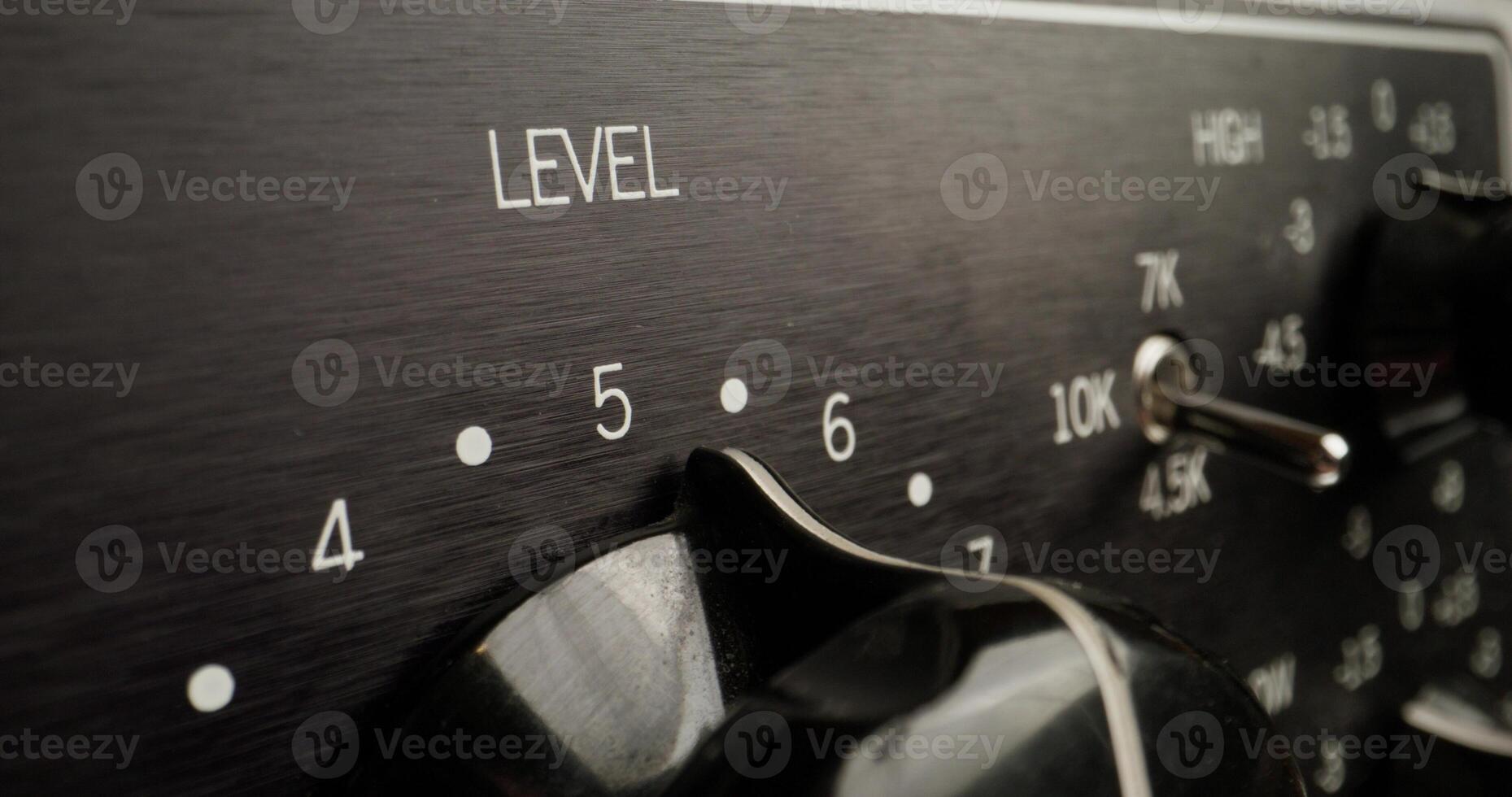 A man adjusts a device to measure the sound level, close-up of his hand, an unrecognizable person photo