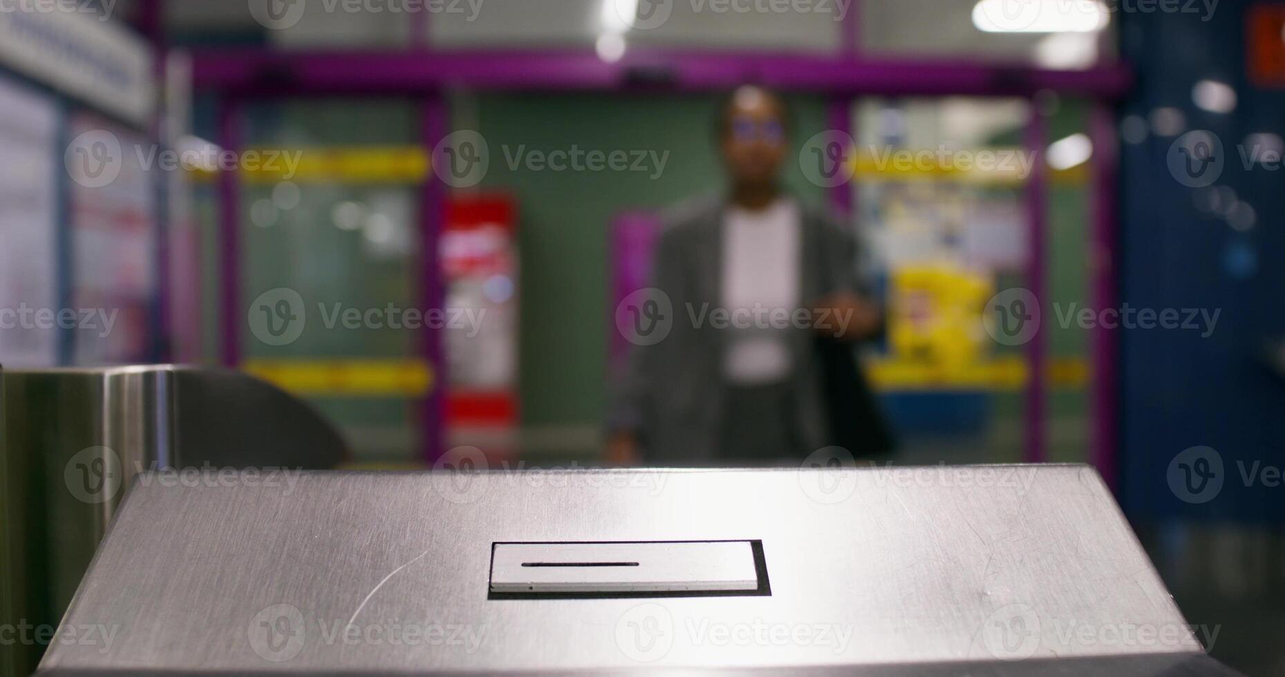 A woman inserts a ticket into a subway terminal. Close-up of her hands, an unrecognizable person photo