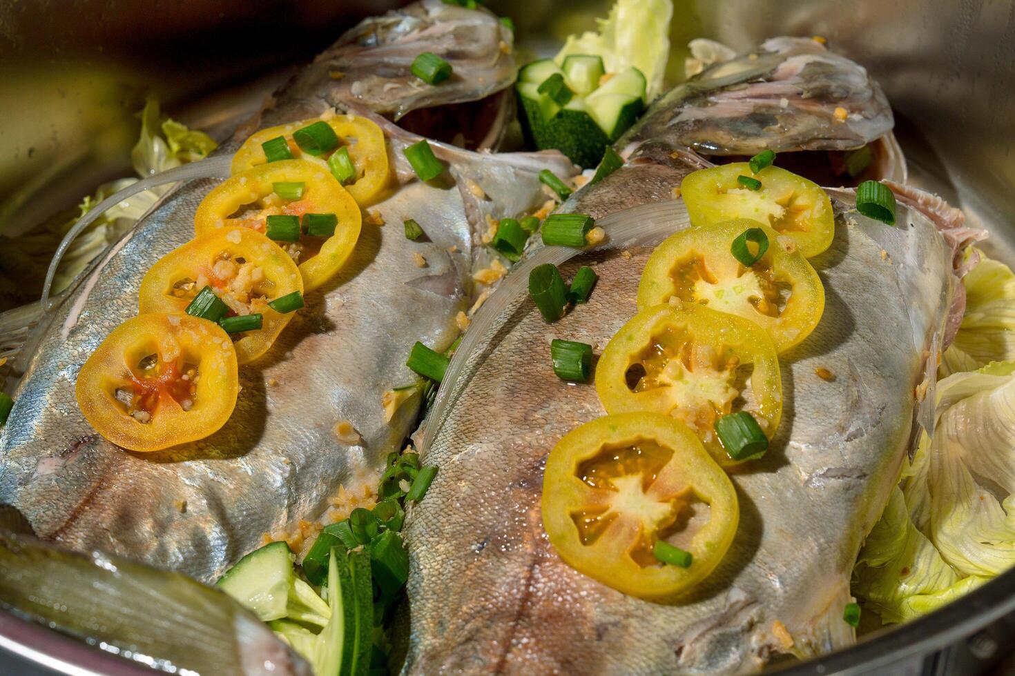 steamed fish with tomato garnish photo