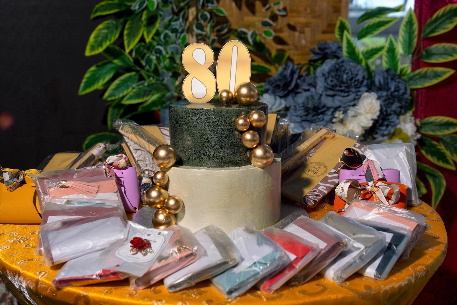 a cake with a number 80 on it and a bunch of gifts photo