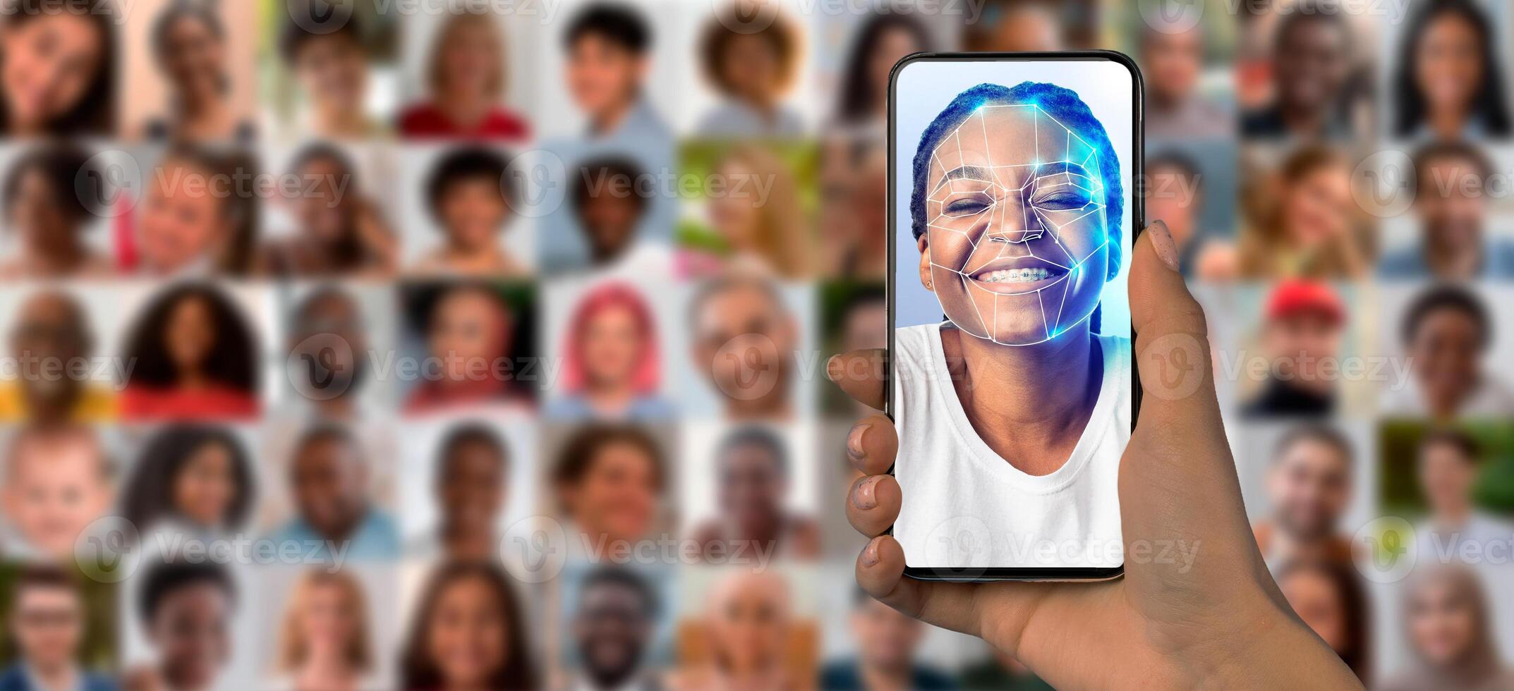 A person holds a smartphone with a face scan, surrounded by a collage of diverse portraits, emphasizing modern identification technology. photo