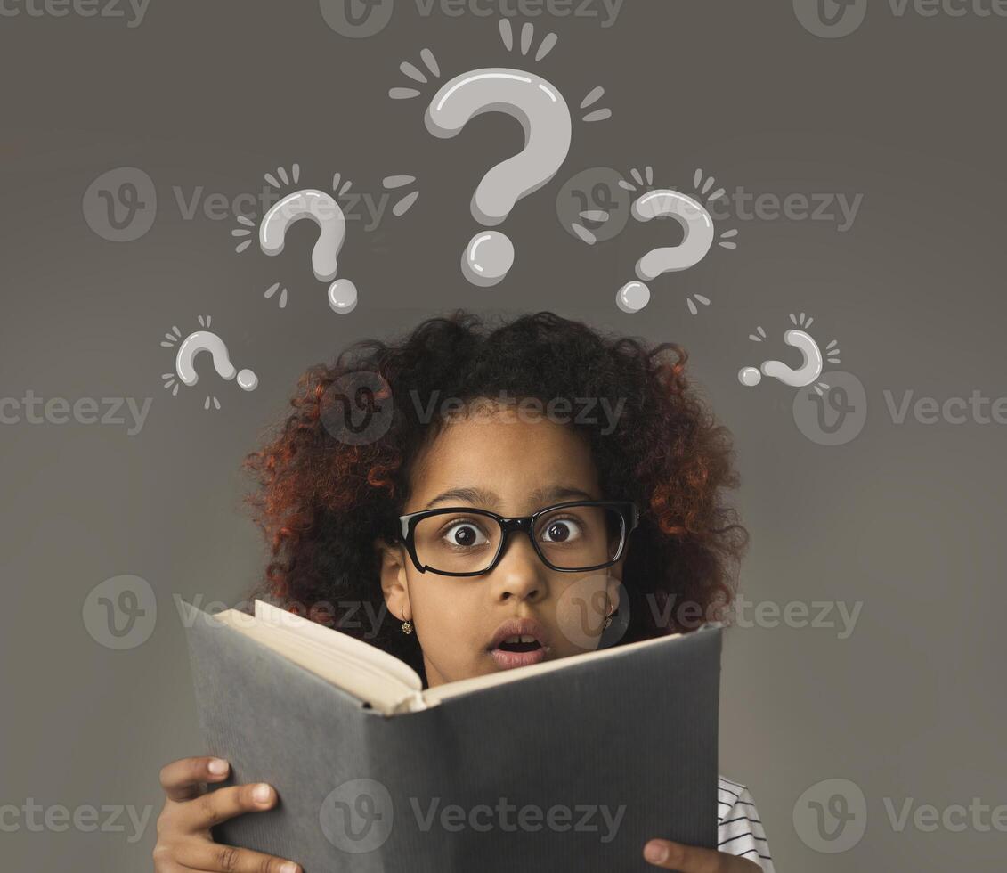 Puzzled black girl with book having trouble understanding school program, collage with question marks. Curious African American child studying alone. Little genius solving problem photo