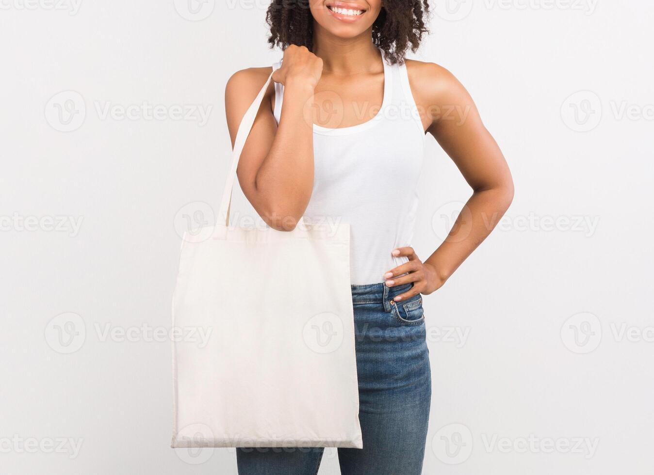 Ecology Concept. Unrecognizable african woman with tote bag over isolated white studio background. Mockup, free space photo