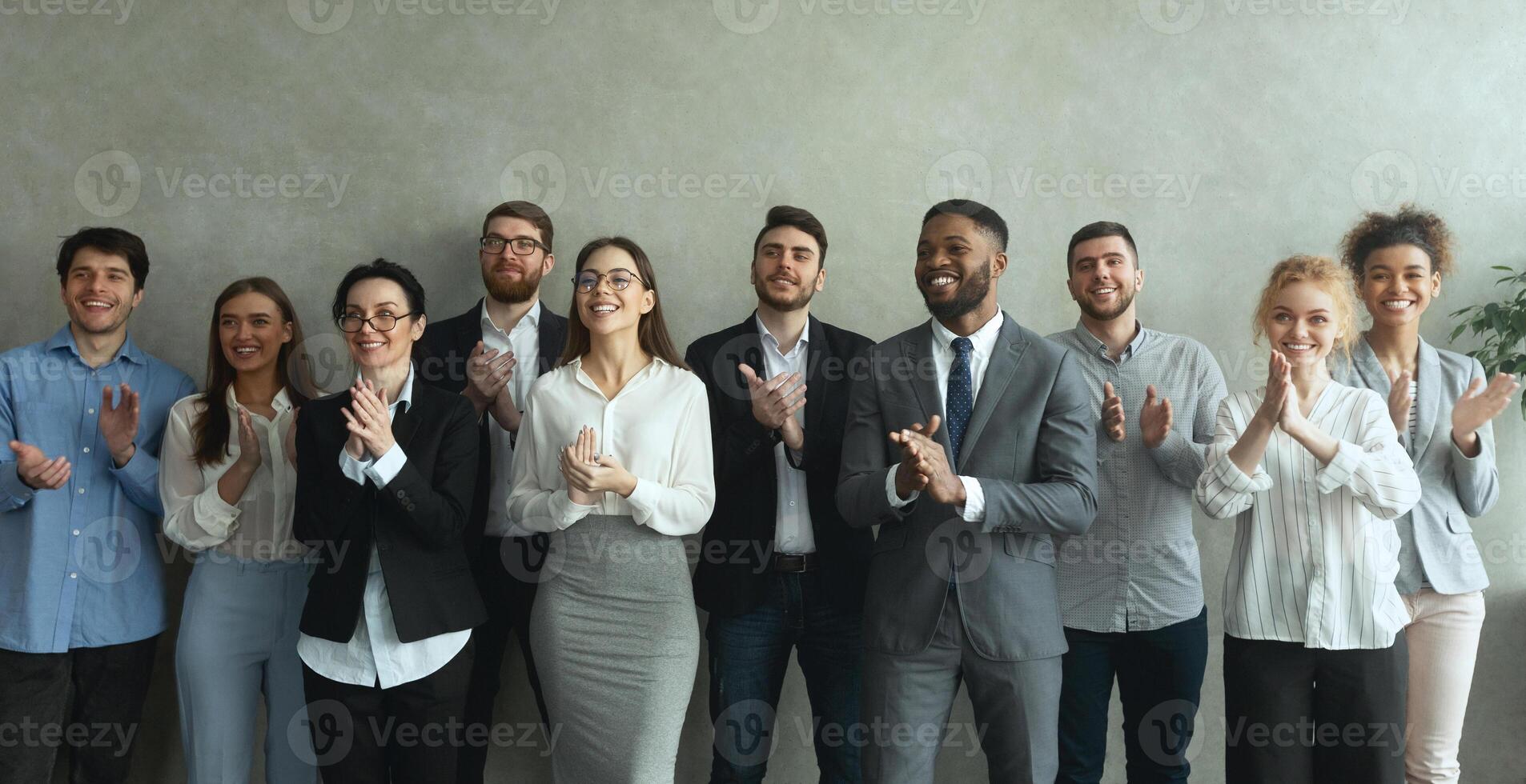 Group of business people clapping hands to congratulate boss, standing ovation after successful meeting photo