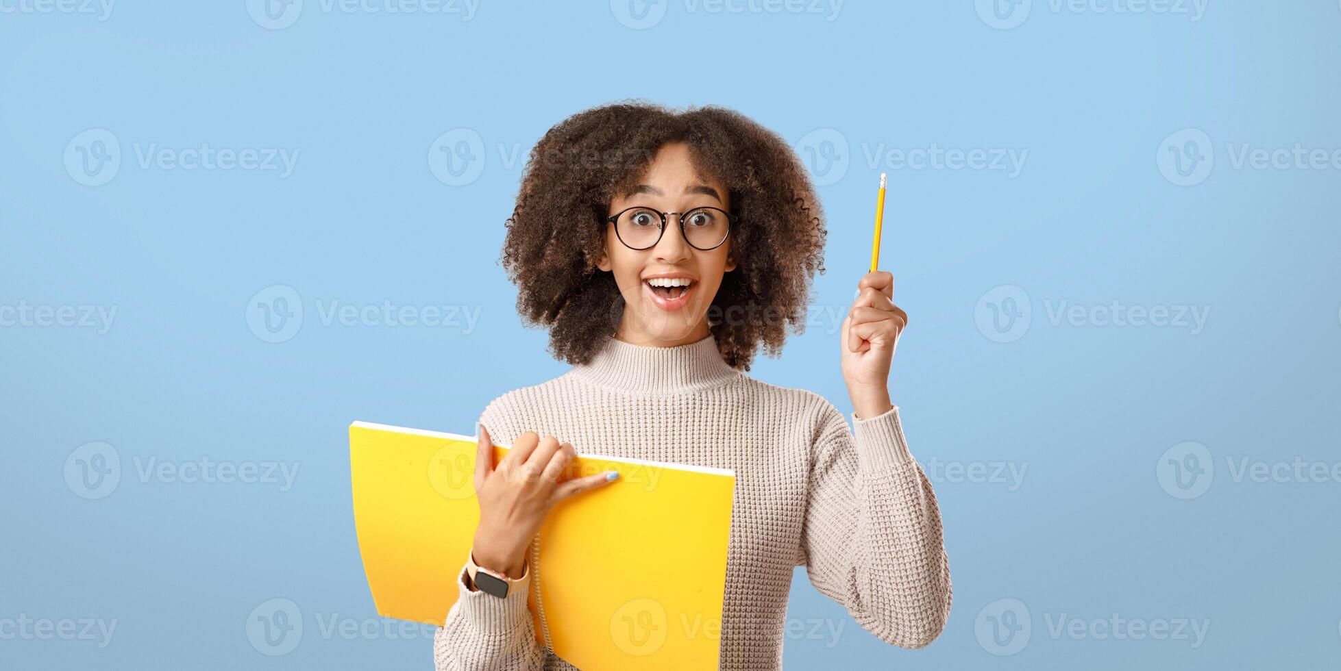 Great idea for education or training project. Surprise african american woman in glasses, with open mouth and notepad, raises pencil up isolated on light background, panorama, studio shot, free space photo