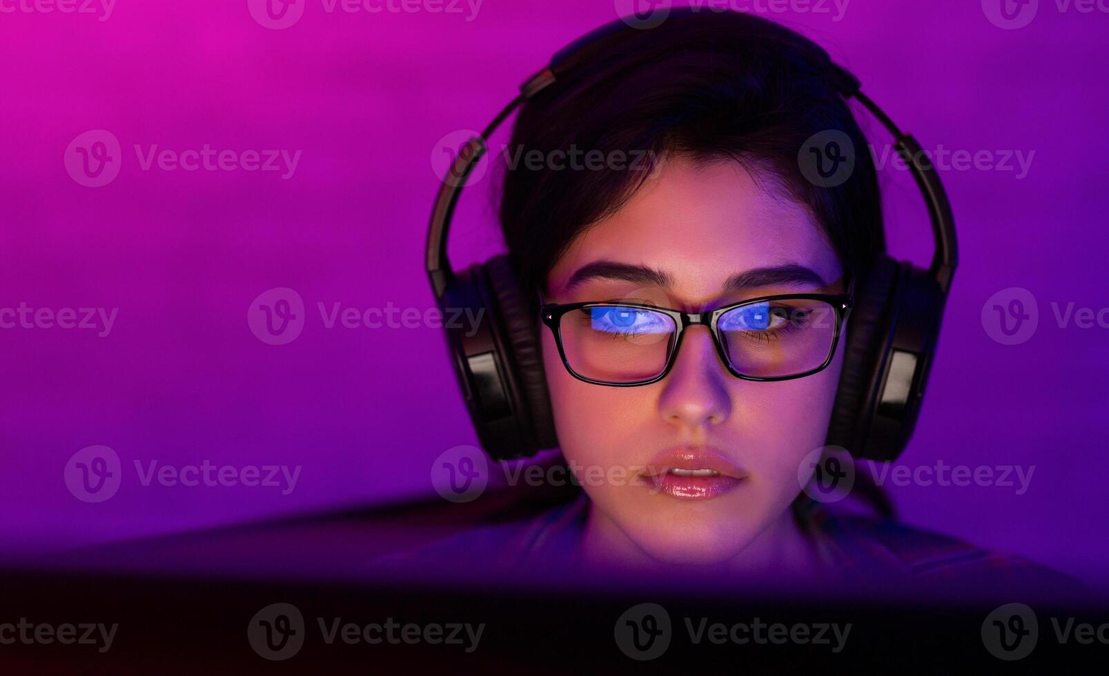 Professional Female Gamer Playing Online Videogame On Computer At Home. Low Light, Empty Space, Selective Focus photo