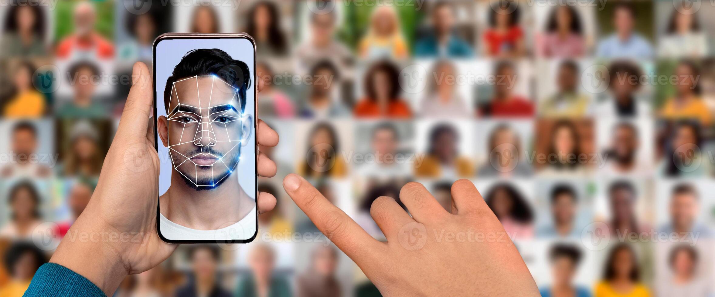 A hand holds a smartphone that scans a face for identification, demonstrating advanced facial recognition technology. Multiple portraits of people in the background enhance the modern feel. photo