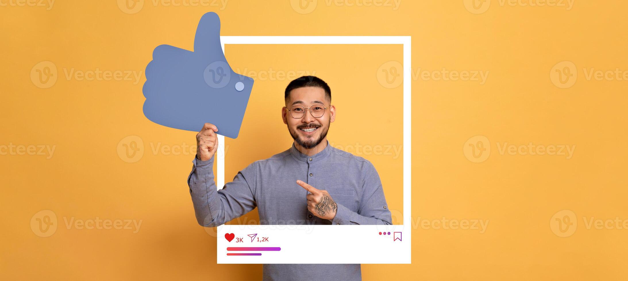 A cheerful content creator poses against a bright orange background, highlighting a thumbs up gesture. photo