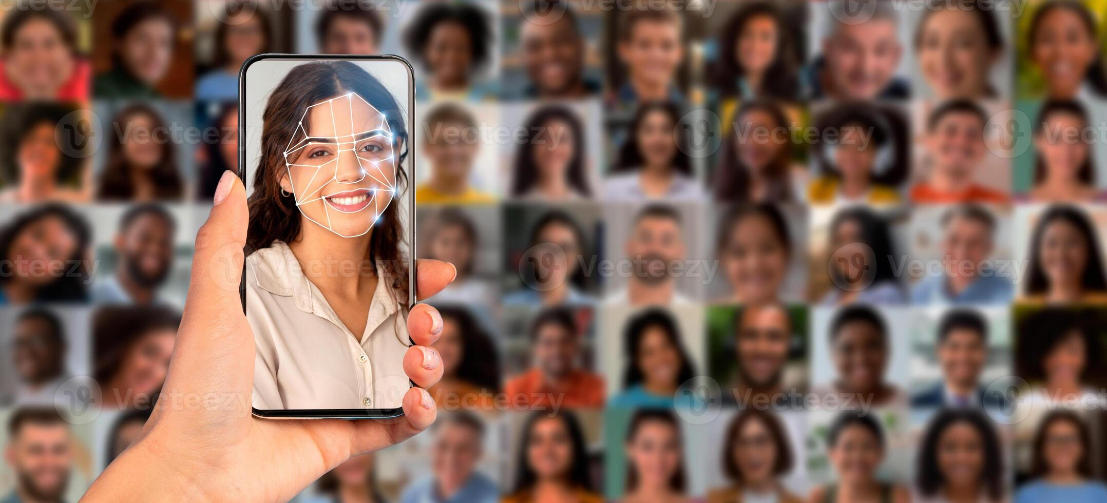 A hand holds a smartphone displaying facial recognition technology. The device scans a person's face against a collage of diverse portraits, showcasing modern identification methods in action. photo