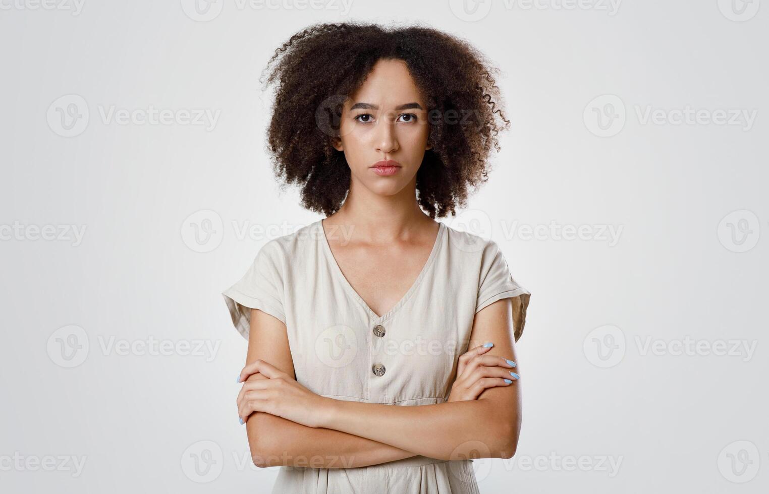 Resentment and upset, emotions and facial expressions. Strict offended millennial african american curly female student in casual, crossed arms and sadly looks at camera, isolated on gray background photo
