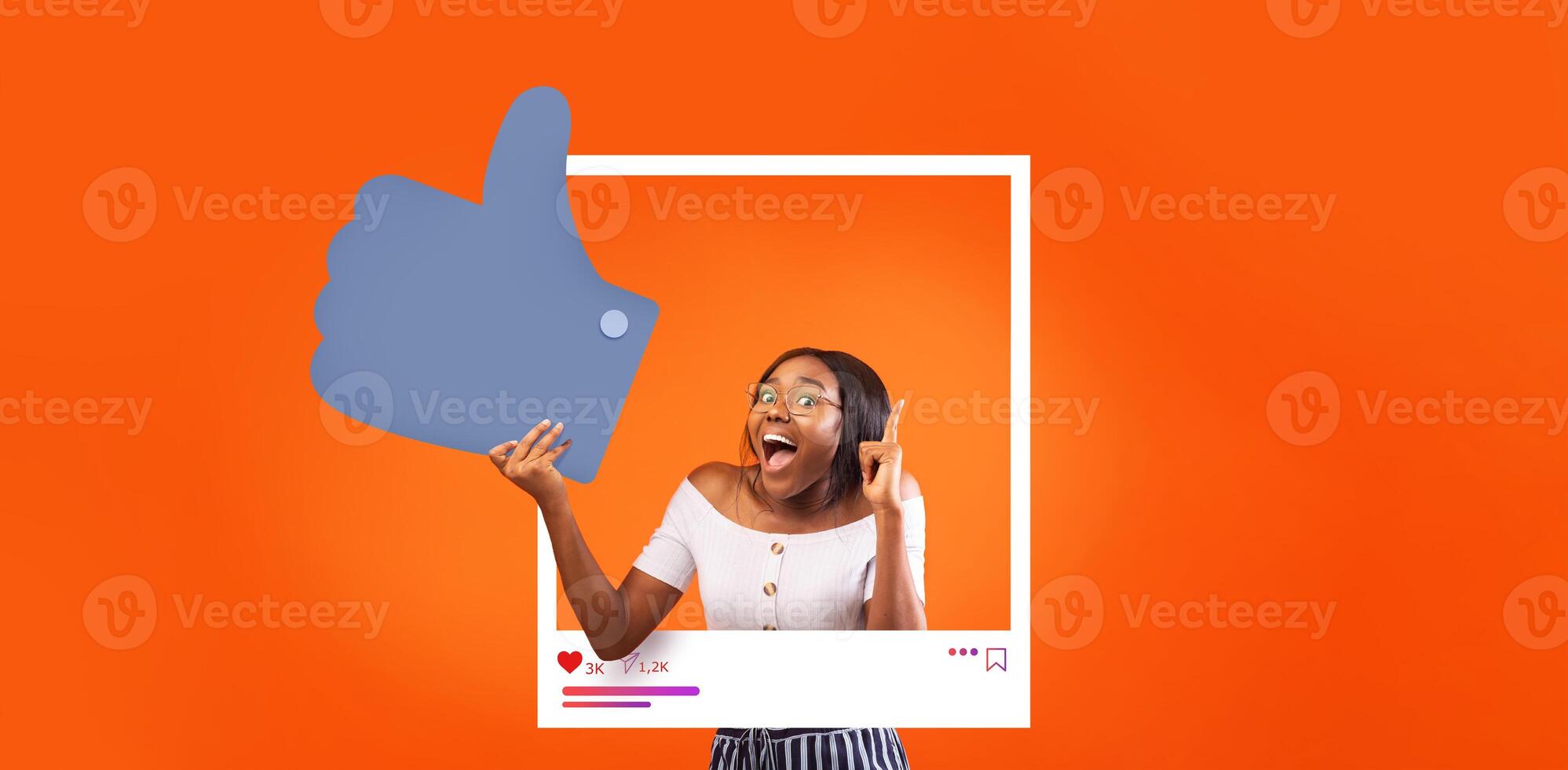A young woman enthusiastically poses with a thumbs up, showcasing her excitement as an influencer. Bright orange background adds to the vibrant, positive atmosphere surrounding her online presence. photo