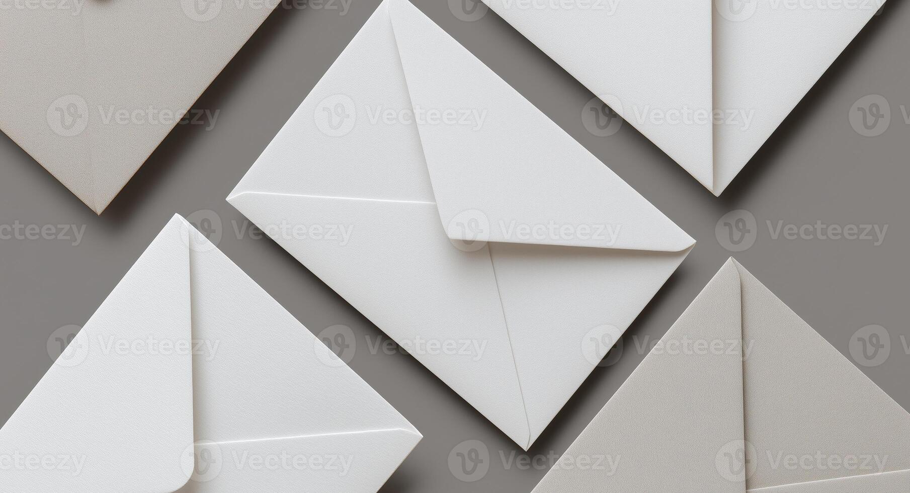 Envelopes in shades of white and light gray are artfully arranged against a neutral backdrop. The minimalistic design suggests a focus on sustainability in stationery choices and communication. photo