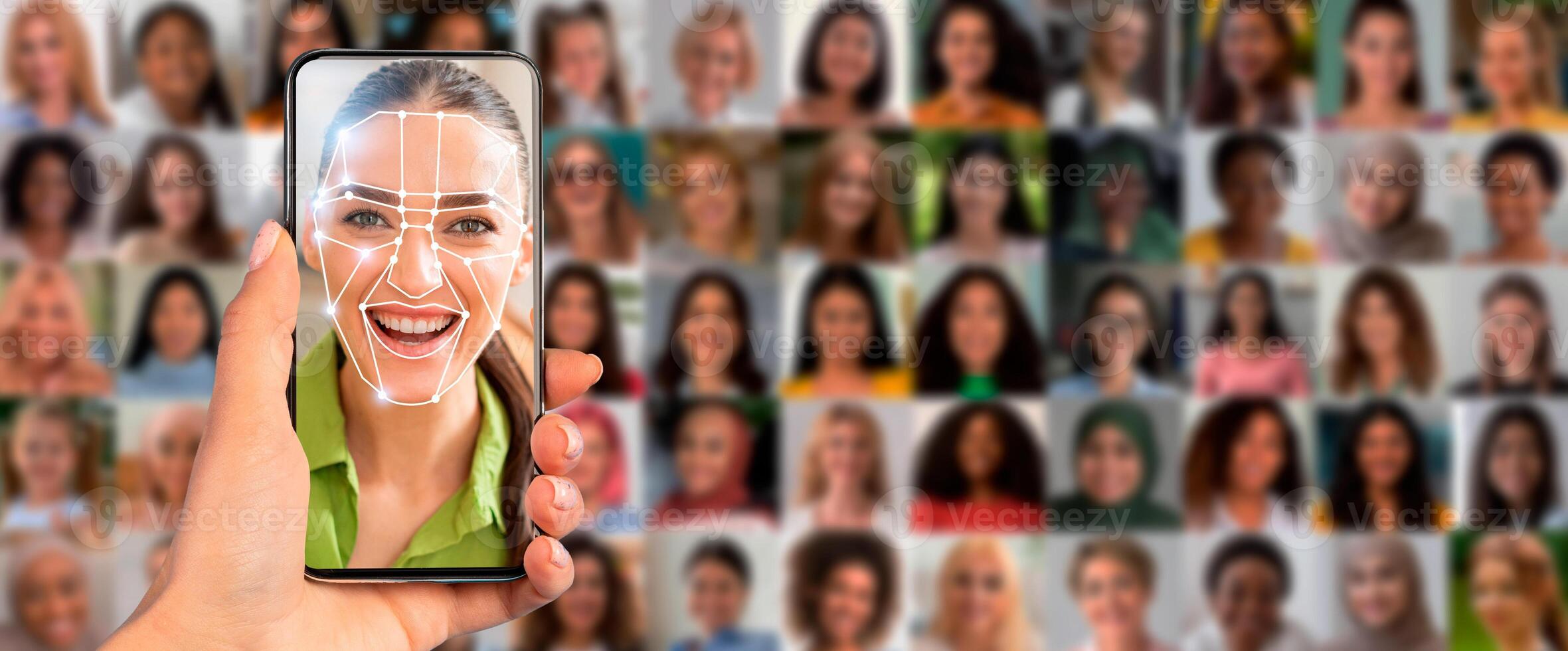A person holds a smartphone displaying a facial scan of a smiling individual, surrounded by a collage of diverse faces in a vibrant, tech-focused atmosphere. photo