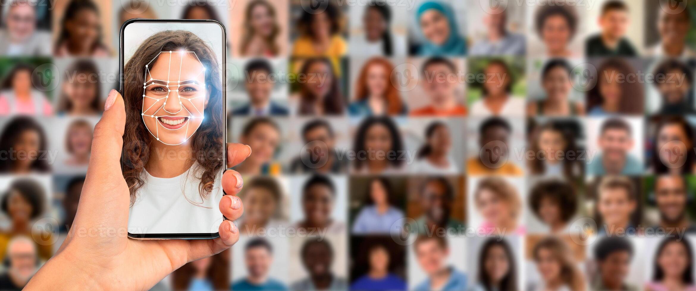 A person holds a smartphone displaying a facial recognition scan in a busy environment. Behind, a collage of diverse faces illustrates modern identification technology's extensive application. photo