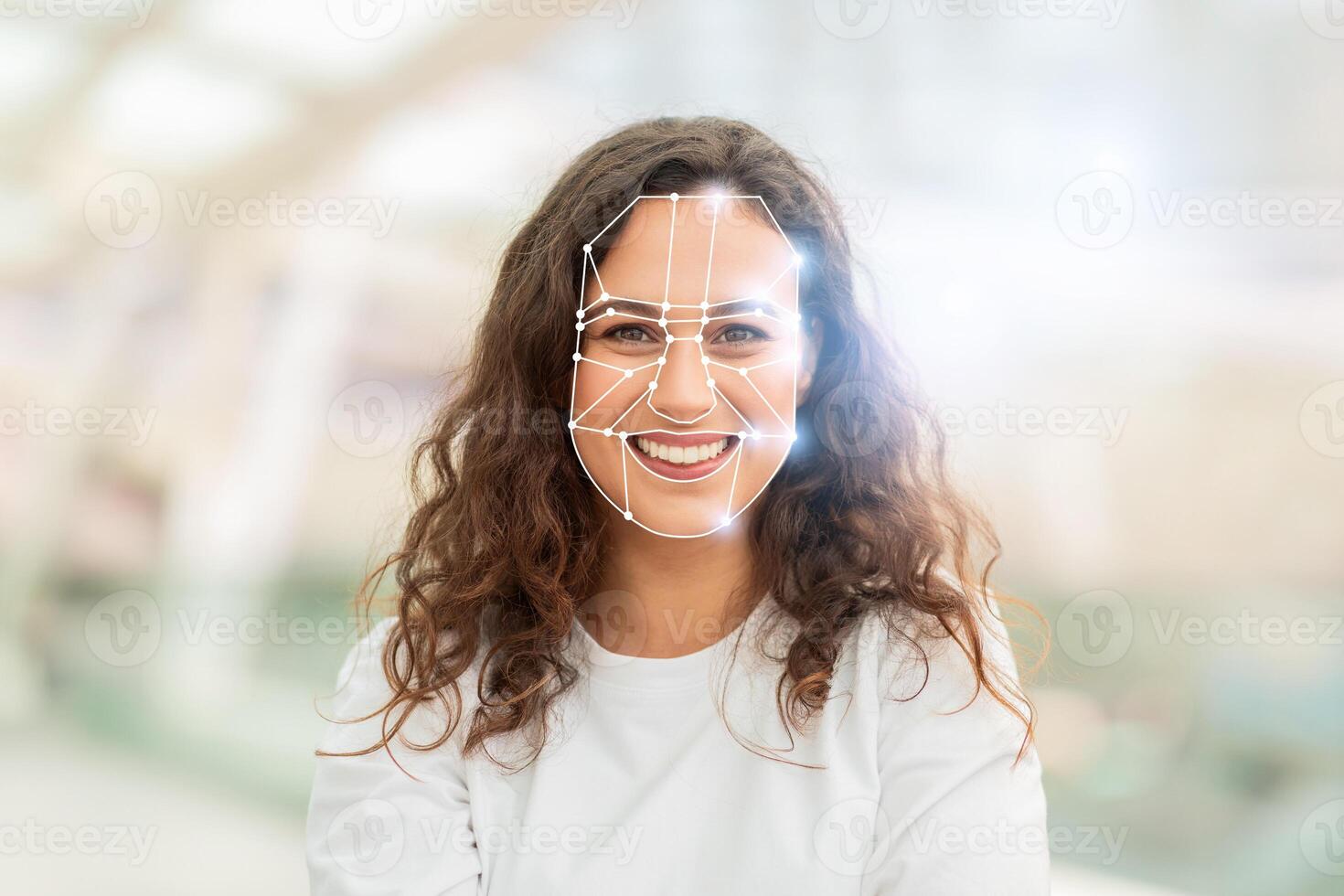 A woman smiles while undergoing facial recognition at a tech facility. This advanced identification method reflects the growing trend of modern technologies in everyday life. photo